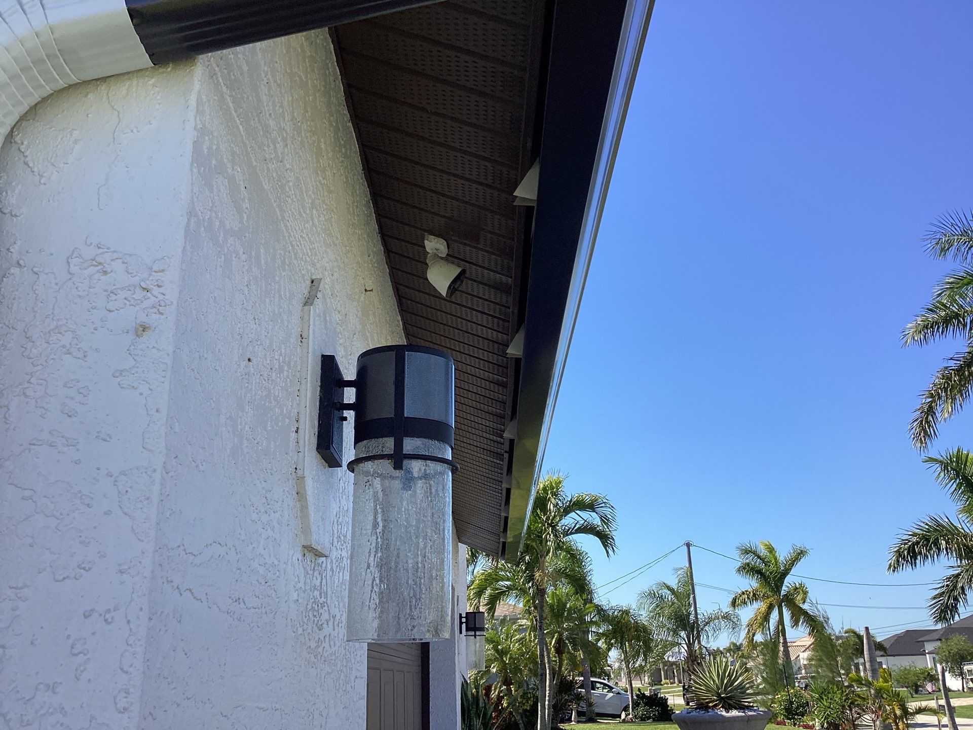 Brown Gutter + White and Brown Downspouts in Cape Coral FL by Gutter Professors