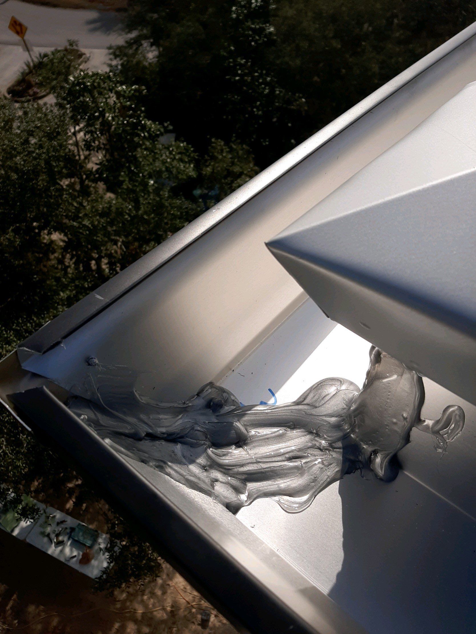 Seamless Gutter Installation Using Black Half Round Seamless Gutters by Gutter Professors
