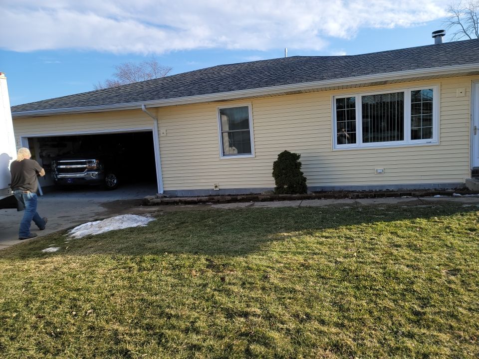 taking down brick wall & installing siding by Kraz Construction