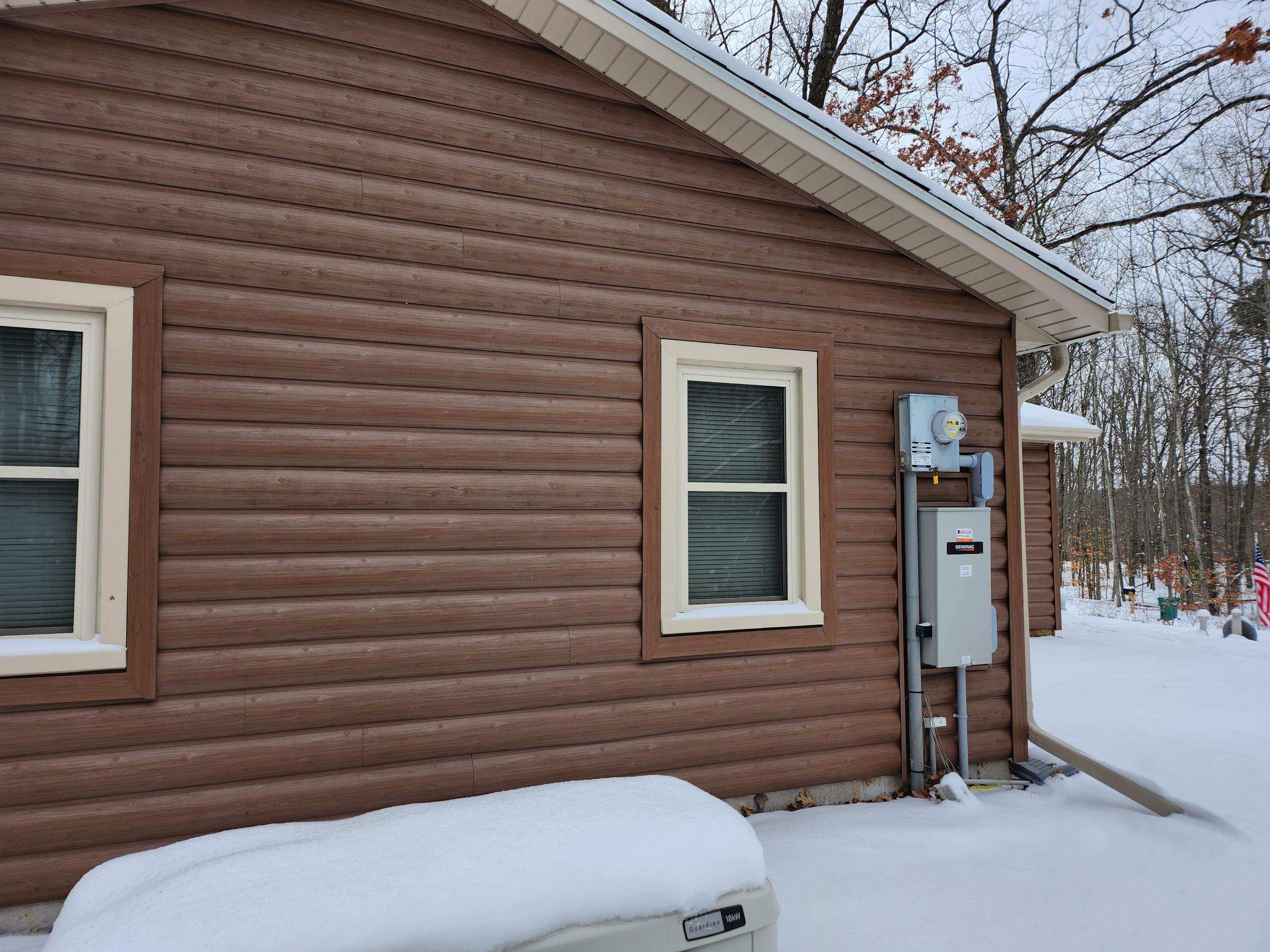 New addition and log siding by Energy Plus Home Improvements