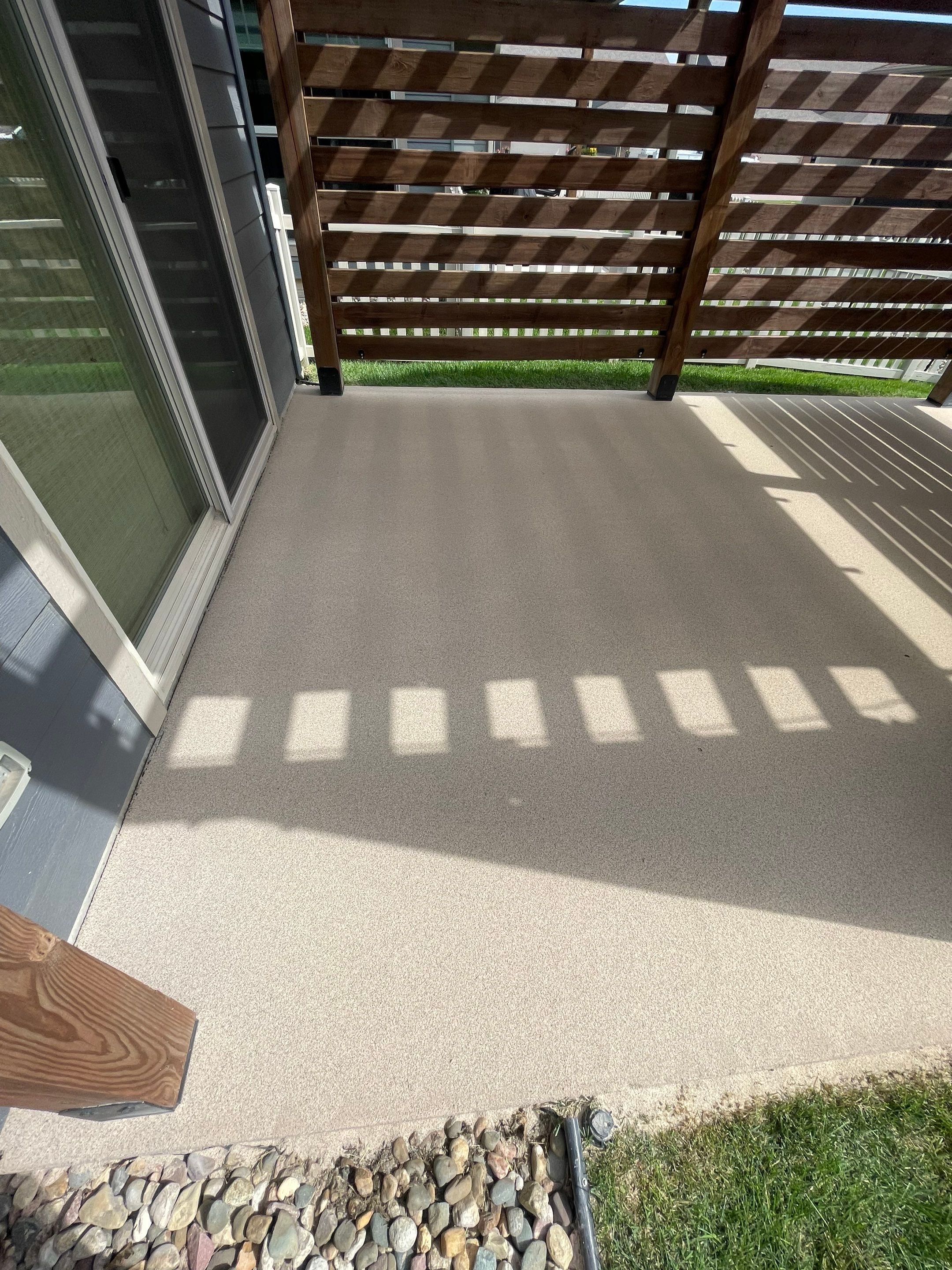 Textured Concrete Patio Coating and Custom Privacy Pergola in Sioux Falls by Select Painting, Coatings & Garage Cabinets