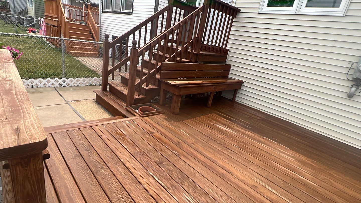 Wood cleaning and staining using Armstrong cloark oil stain by Northern Power Washing LLC.
