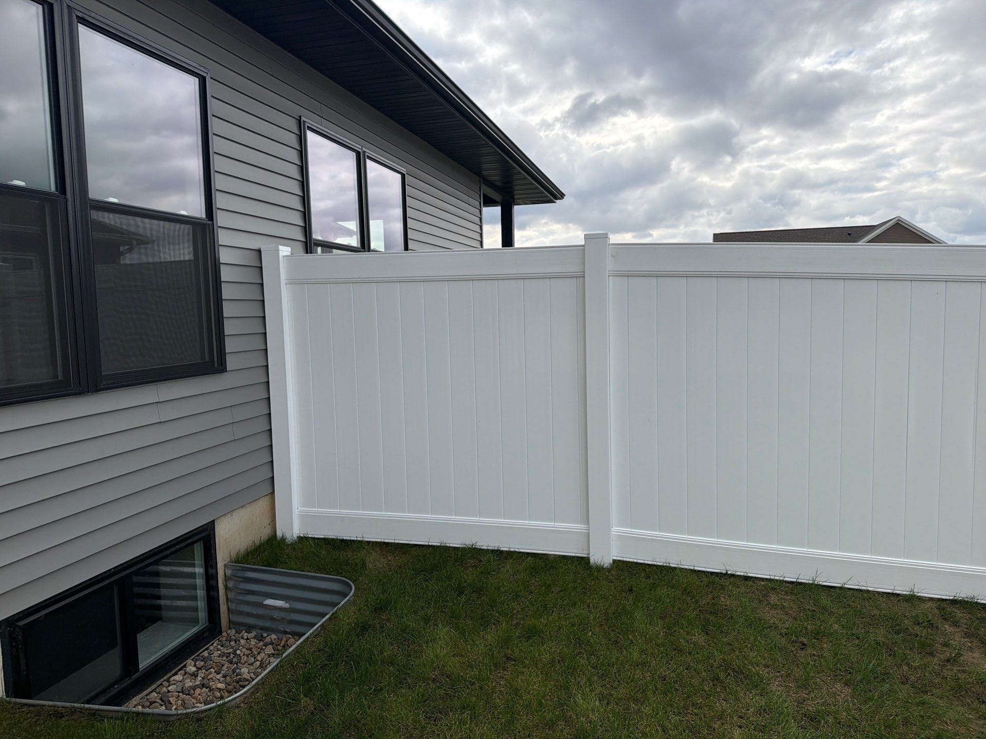 Residential White Vinyl Privacy Fence Installation in Janesville by Perfect Picket Fence and Stain