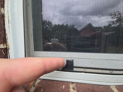 Close up of finger pointing at window screen