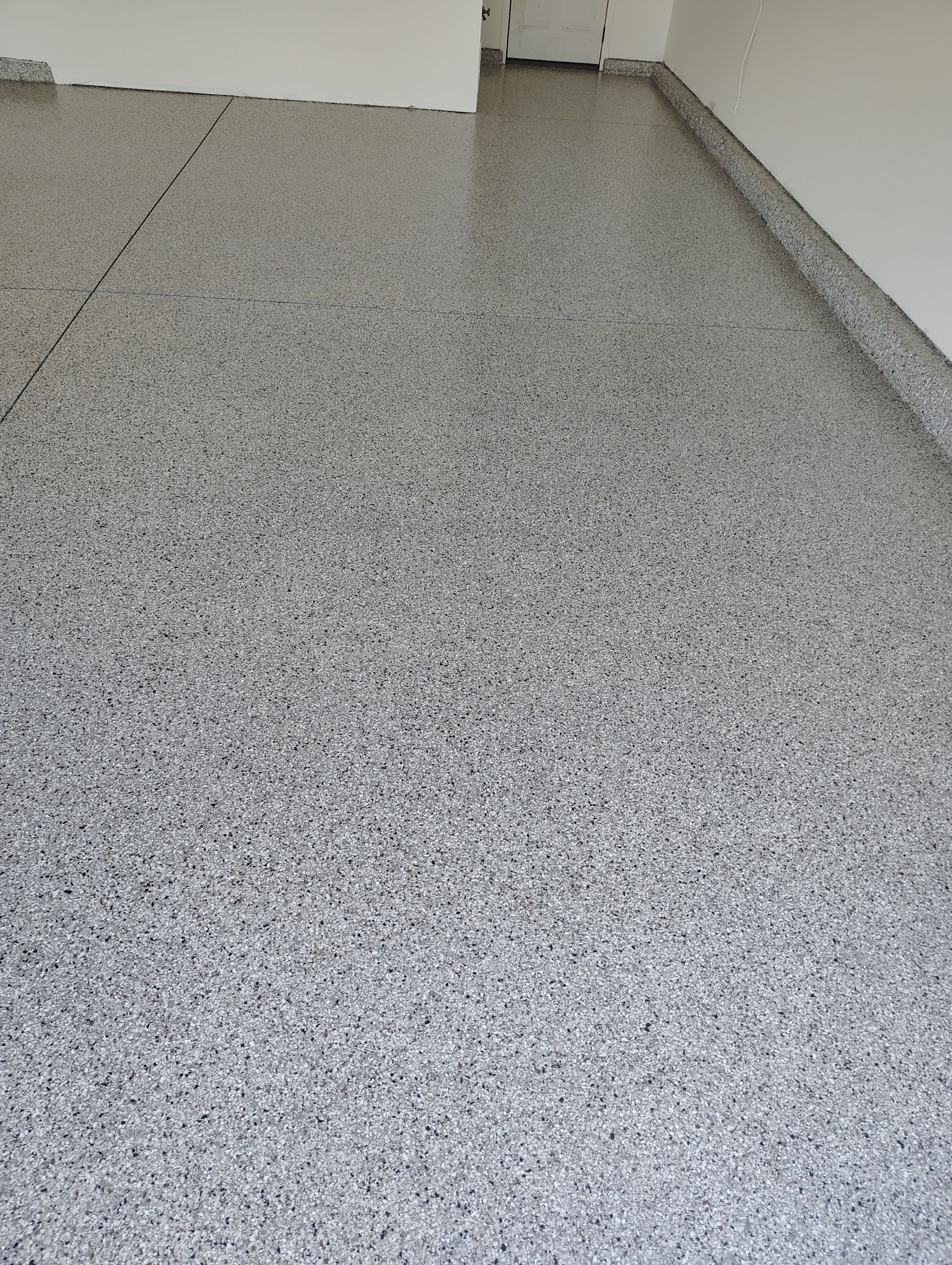 Custom Grey Speckled Epoxy Floor Coating for Sioux Falls Garage by Select Painting, Coatings & Garage Cabinets