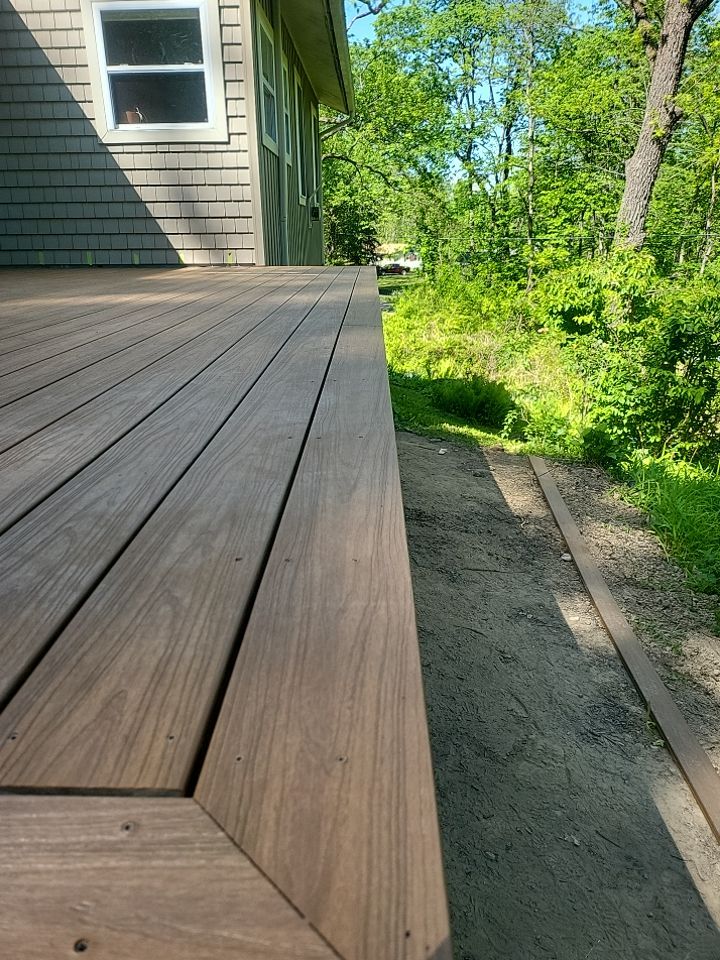 Deck installation using cable railing. by Burke Home Services