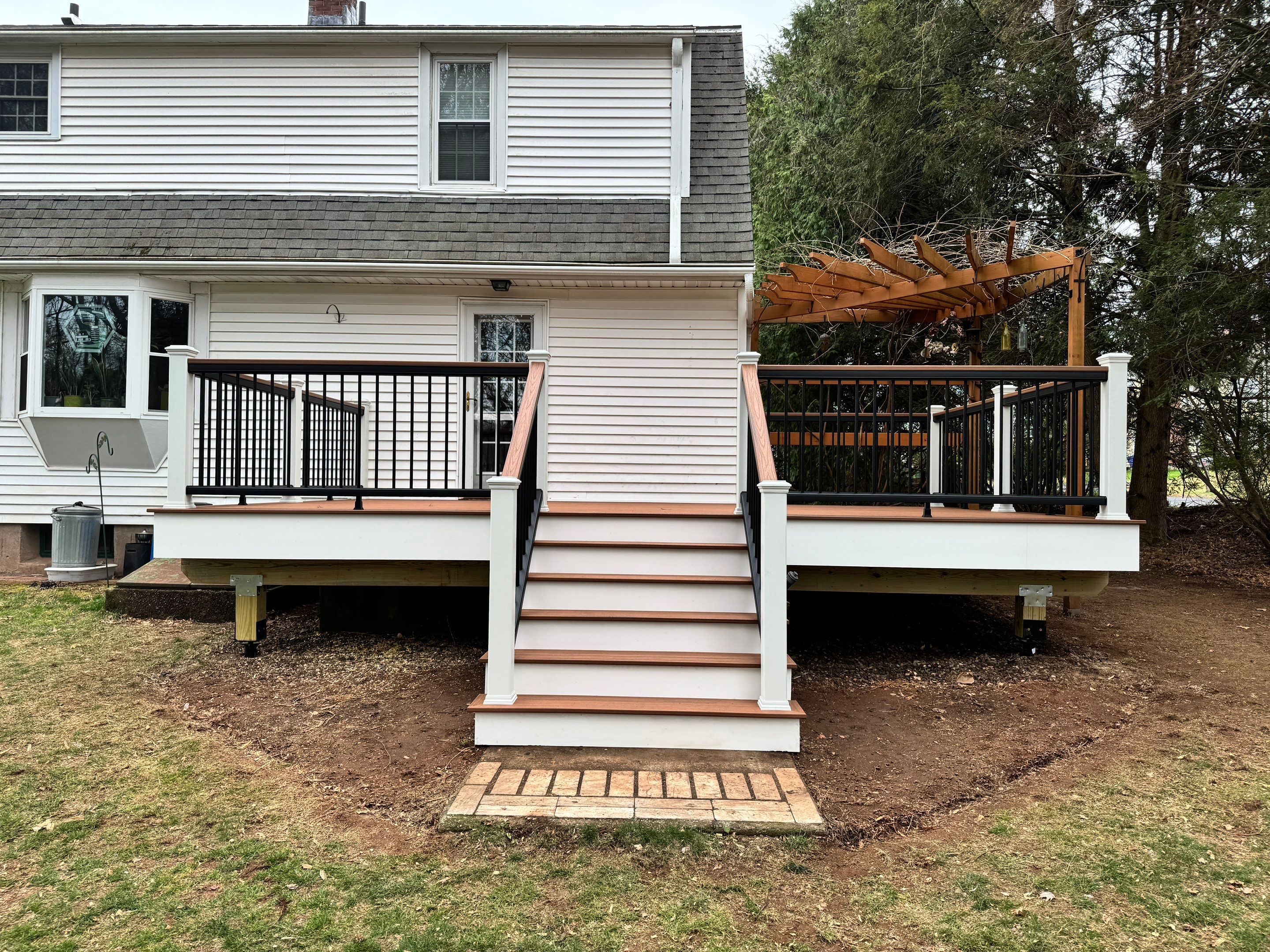 Replacement deck with Trex Transcend Tiki Torch deck boards and matching cocktail rail. by DiGiorgi Roofing and Siding Inc