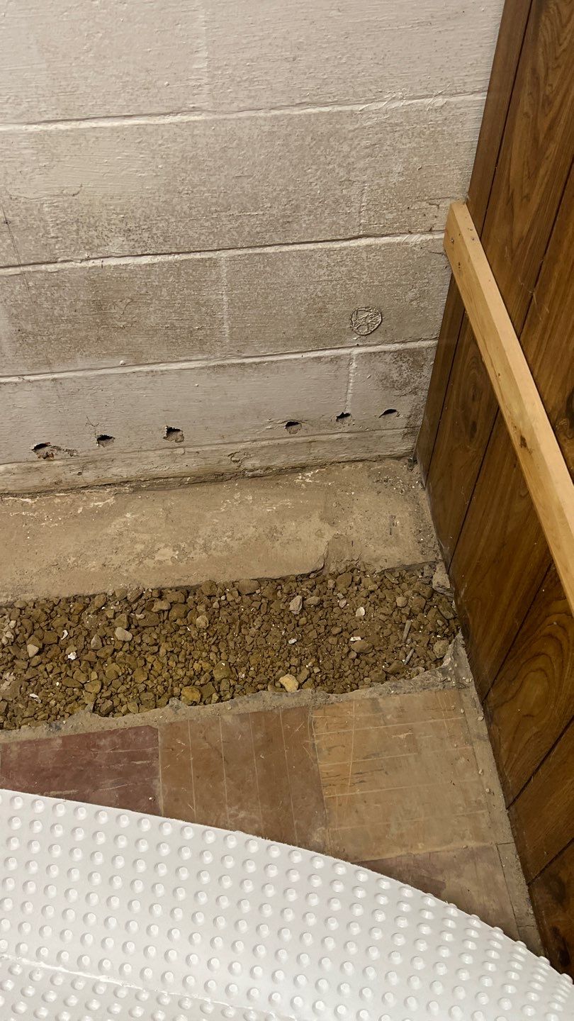 Interior drain tile system installation by ACE Waterproofing & Basement Solutions