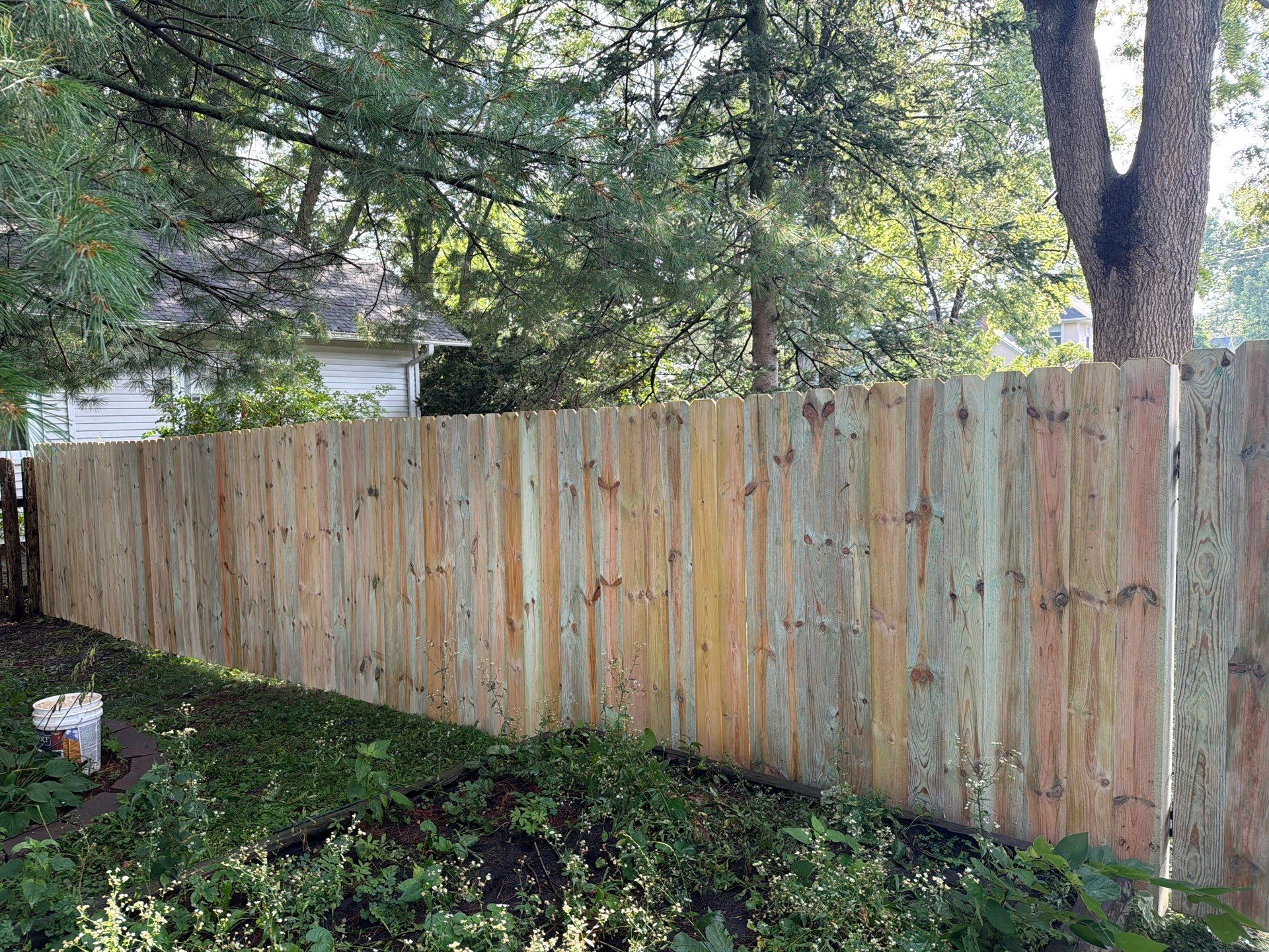 Pressure-Treated Pine Privacy Fence Installation in Cedar Falls by Perfect Picket Fence and Stain