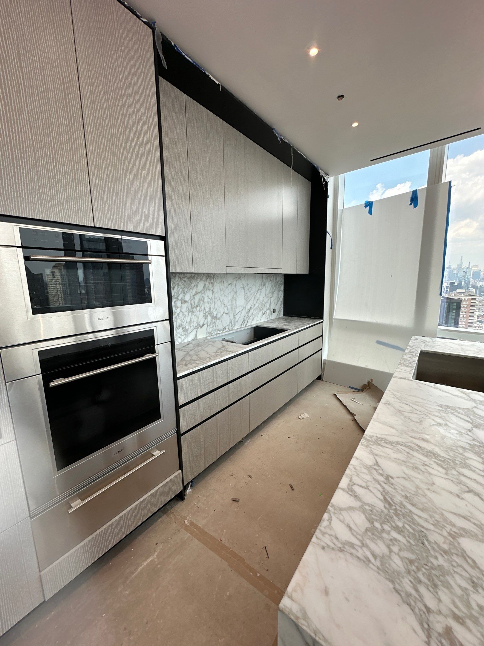 Kitchen Countertop with backsplash and Island top with mitered waterfalls by NC Stone And Tiles