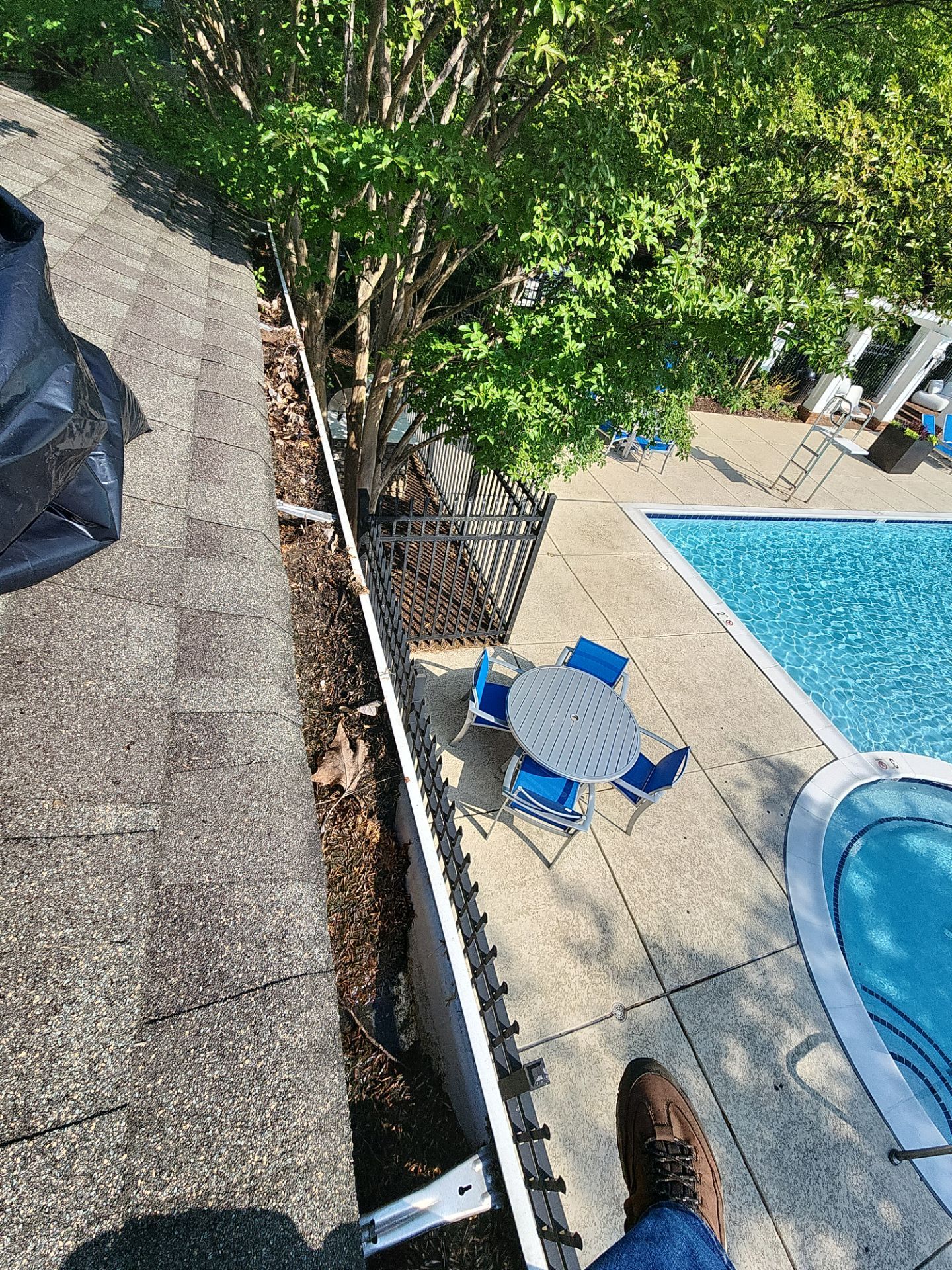 HOA gutter cleaning in Winchester, VA,before  photo showing full gutters.