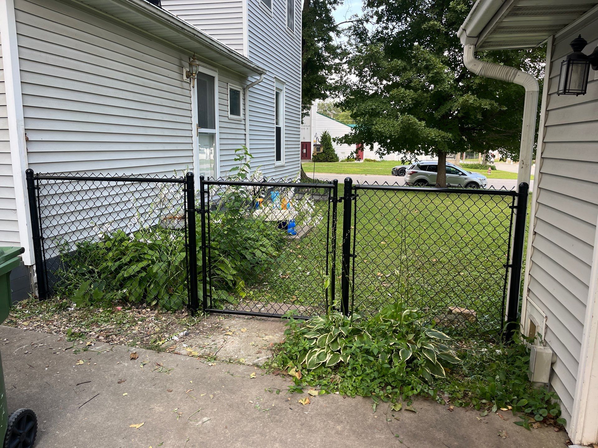Black Chain Link Perimeter Fence and Gate Installation in Shell Rock by Perfect Picket Fence and Stain