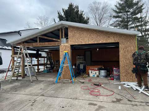 Green Metal Roof Installation and Exterior Renovation in Thornville by Canopy Contracting