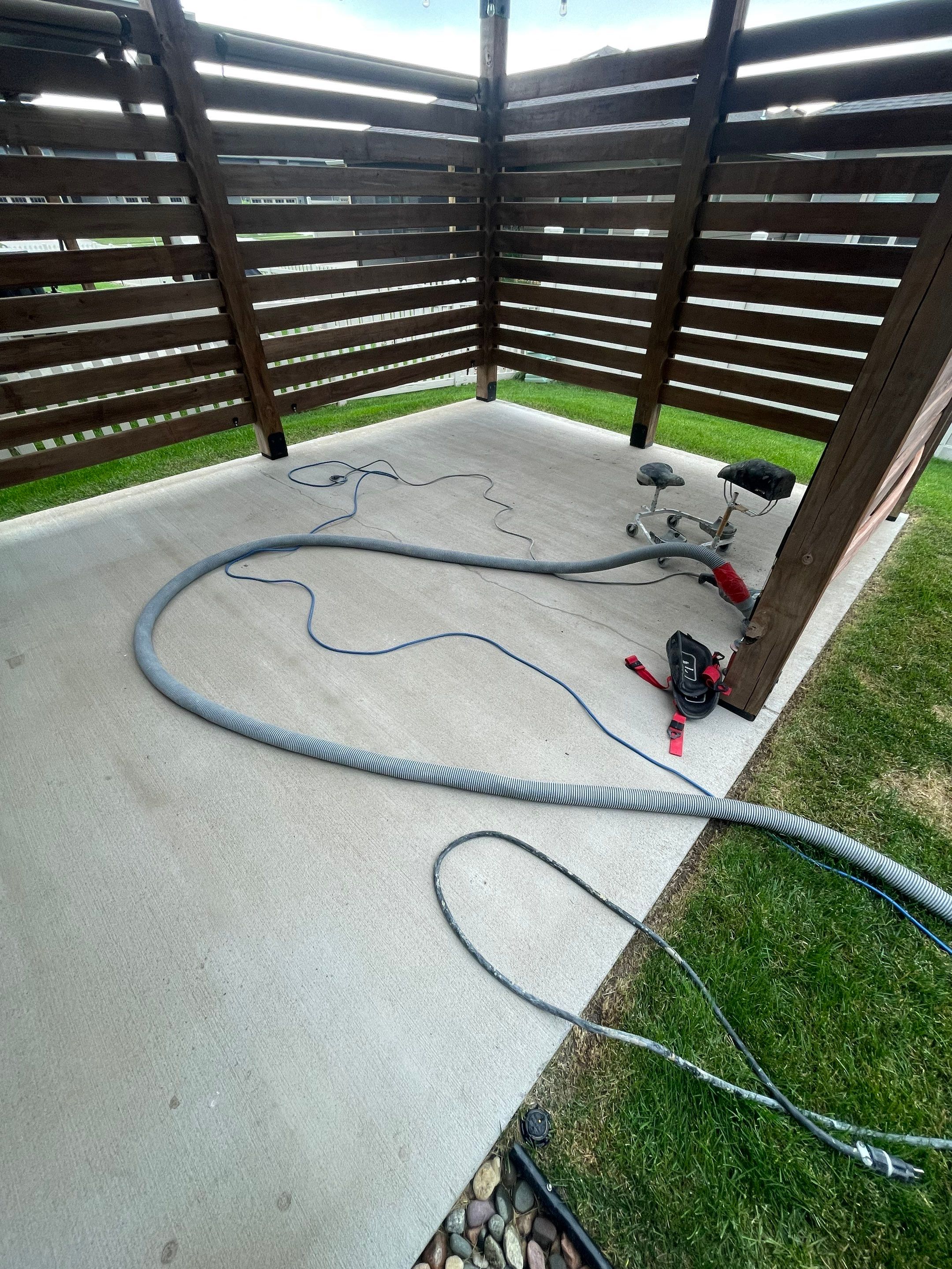Textured Concrete Patio Coating and Custom Privacy Pergola in Sioux Falls by Select Painting, Coatings & Garage Cabinets