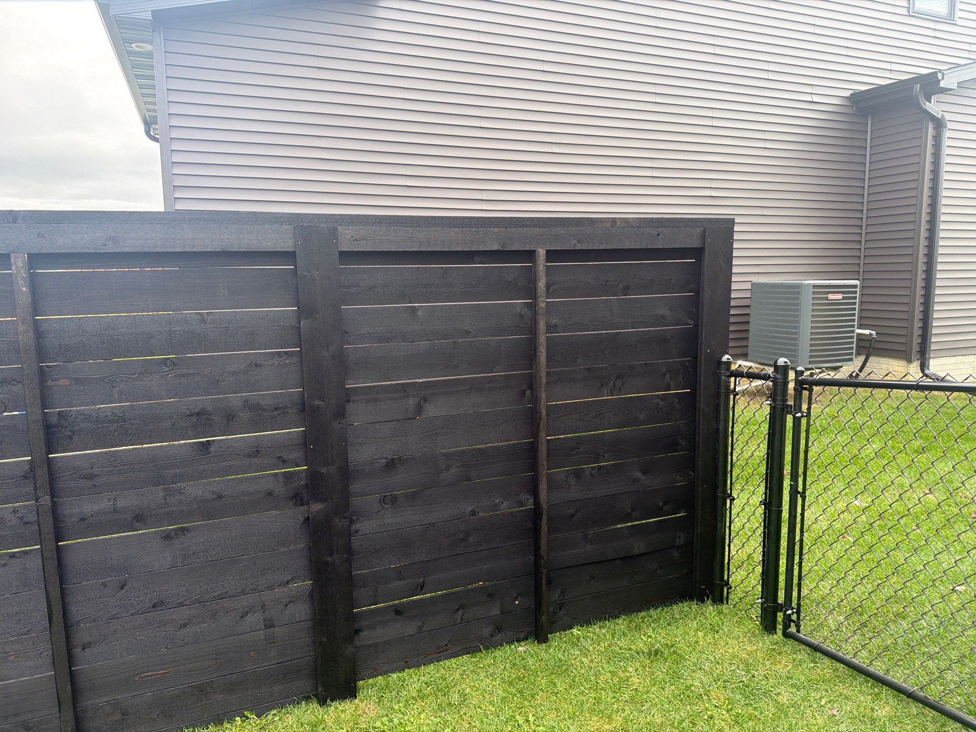 Modern Horizontal Wood Privacy Fence Installation in Cedar Falls by Perfect Picket Fence and Stain