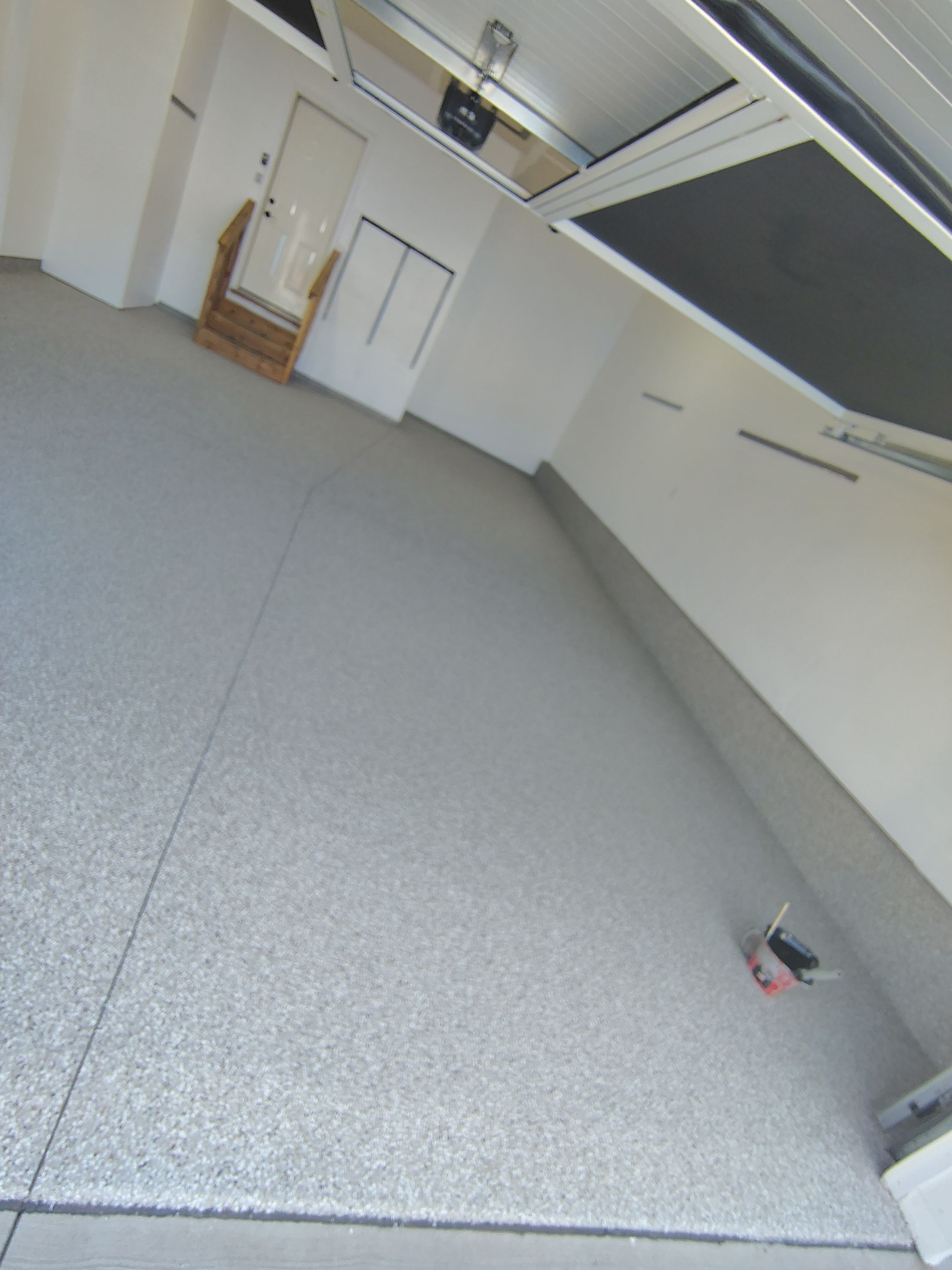 Sioux Falls Garage Floor Transformation With Gray Speckled Epoxy Coating by Select Painting, Coatings & Garage Cabinets
