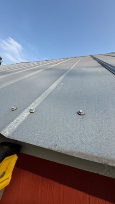 Close up of metal roof panels on red building