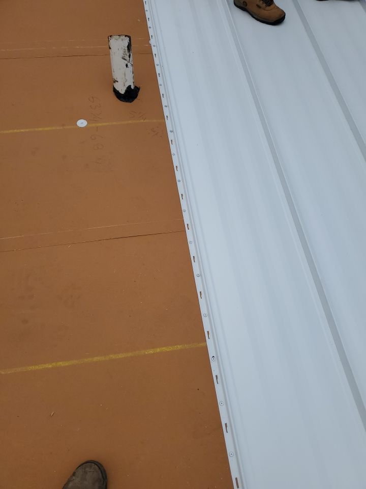 Residential Roofing Installation using 1.5" Nail Strip 24ga Solar White Kynar Coated Standing Seam Metal Panels by Morton Roofing, Inc.