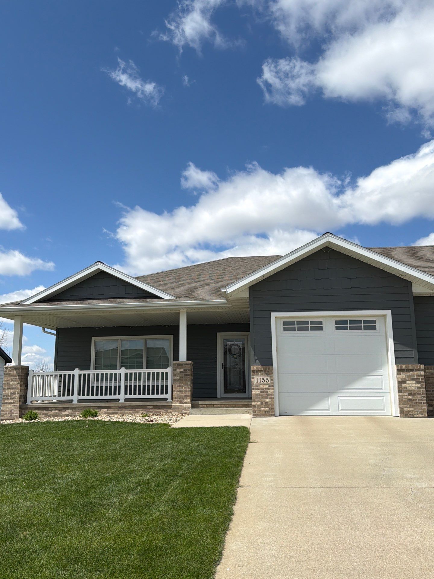 Madison Exterior Remodel with Dark Gray Siding and Stone Accents by Select Painting, Coatings & Garage Cabinets