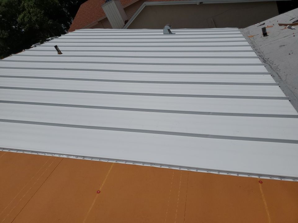 Residential Roofing Installation using 1.5" Nail Strip 24ga Solar White Kynar Coated Standing Seam Metal Panels by Morton Roofing, Inc.