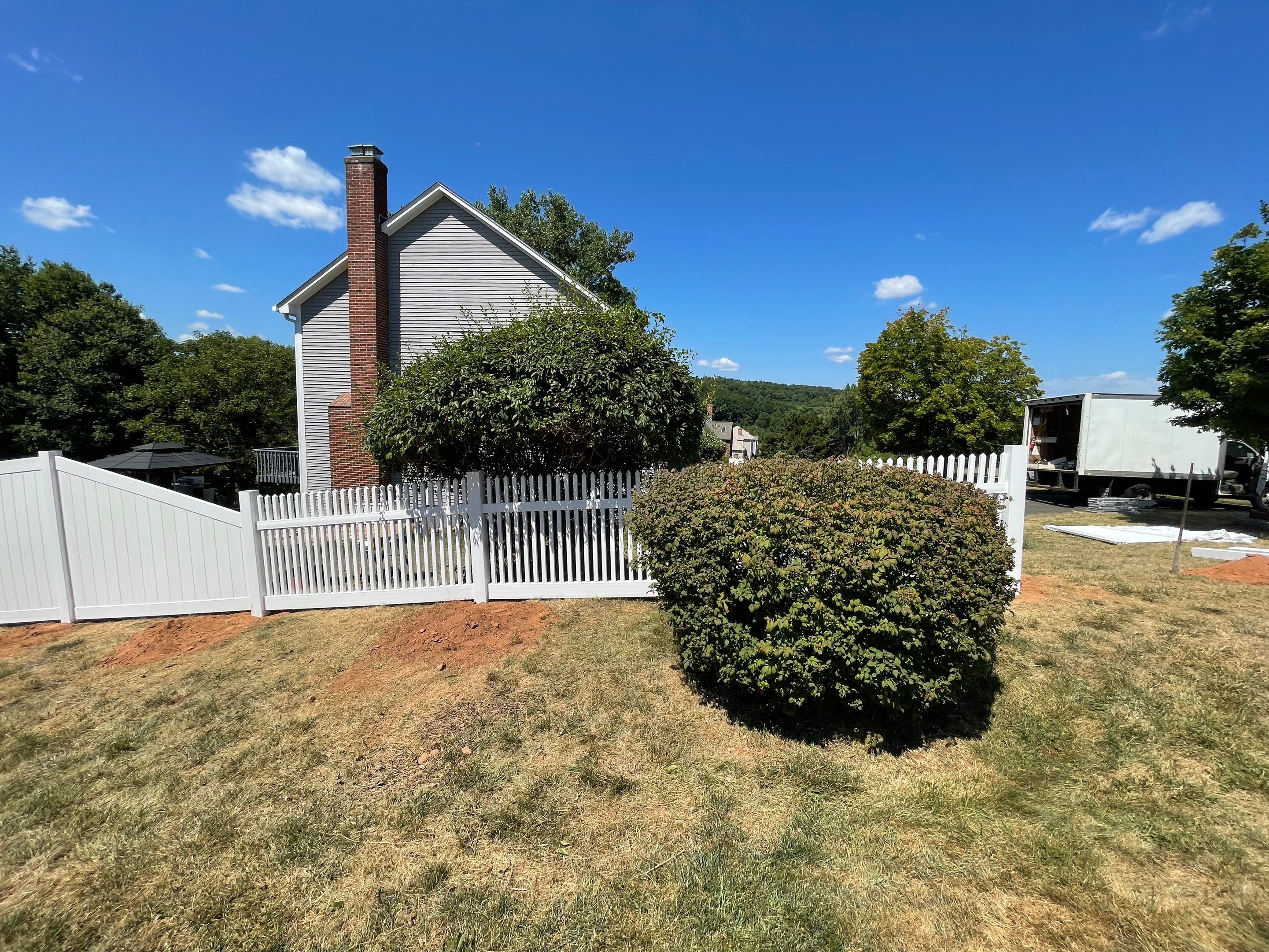 New Vinyl privacy fence and picket fence in white by DiGiorgi Roofing and Siding Inc