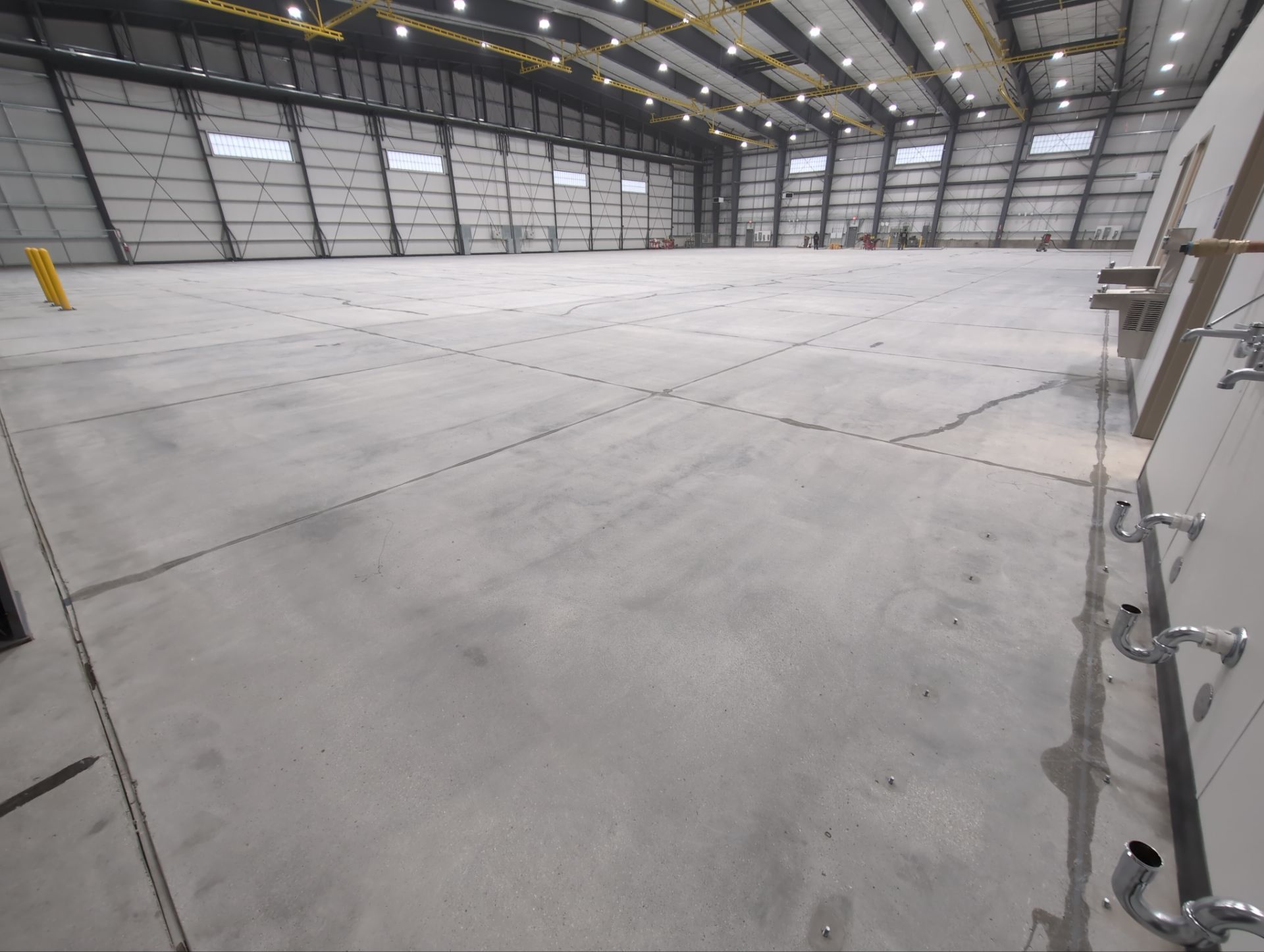 Airplane Hanger using Light Grey Commercial Penntek Epoxy by Croc Coatings, LLC
