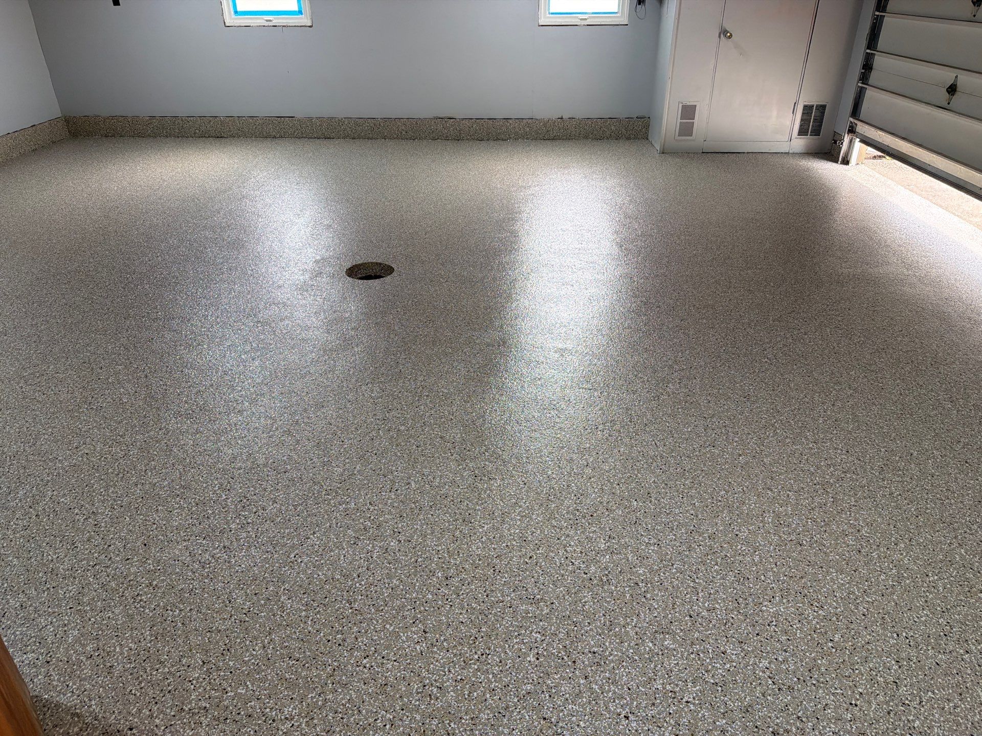 Garage Epoxy Flake Floor Installation and Exterior Siding Repairs in Muskegon by Gordon Painting