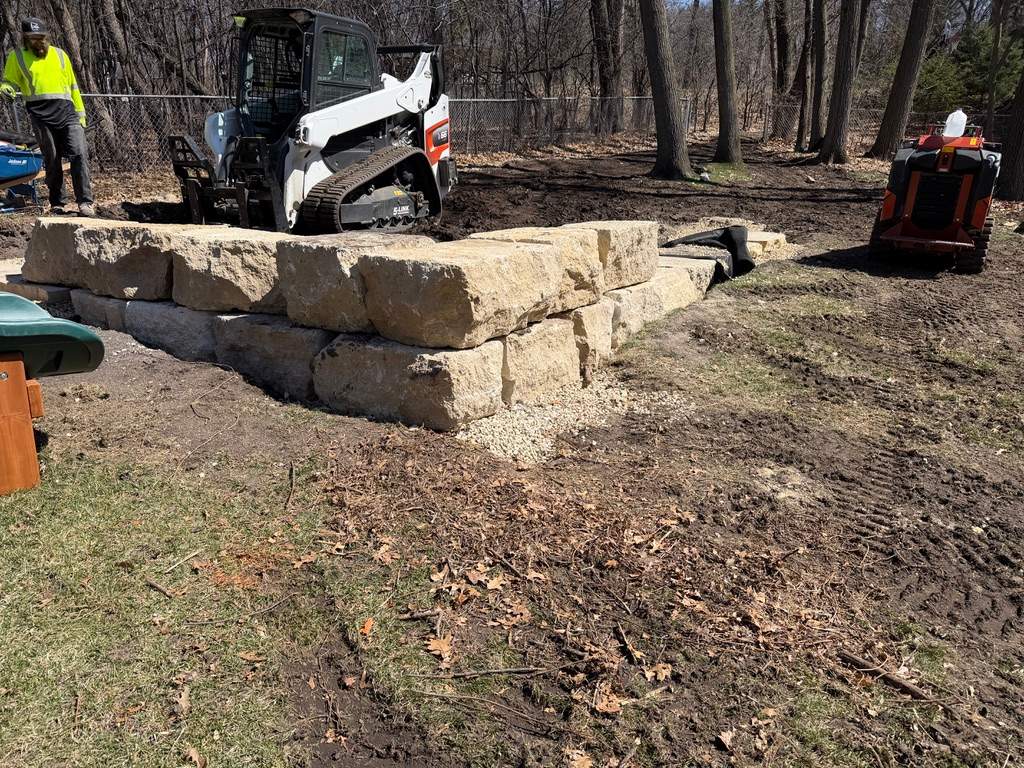Limestone Boulder Wall  by Sota landscaping