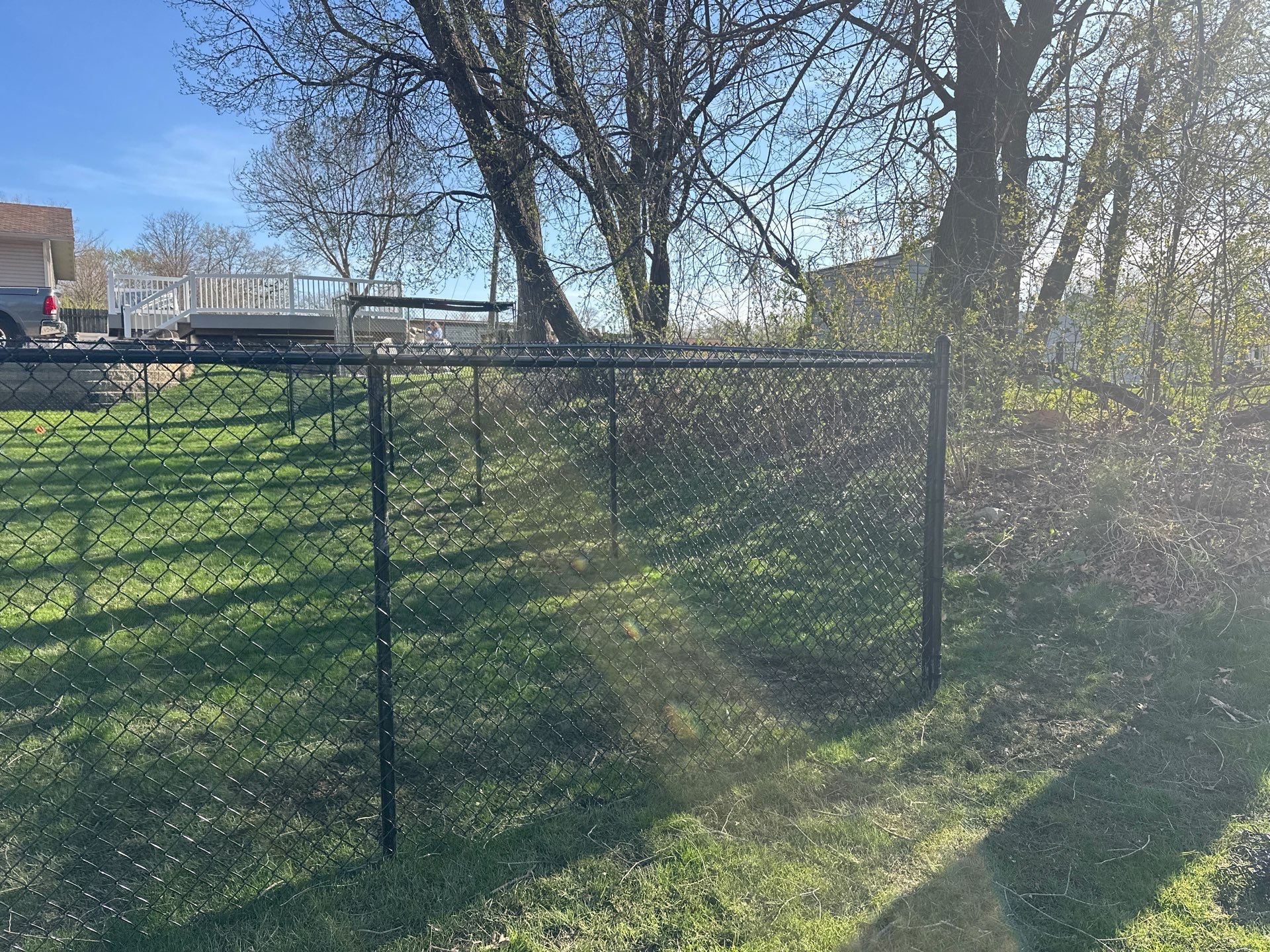 Black Vinyl-Coated Chain Link Fence Installation in Waterloo by Perfect Picket Fence and Stain