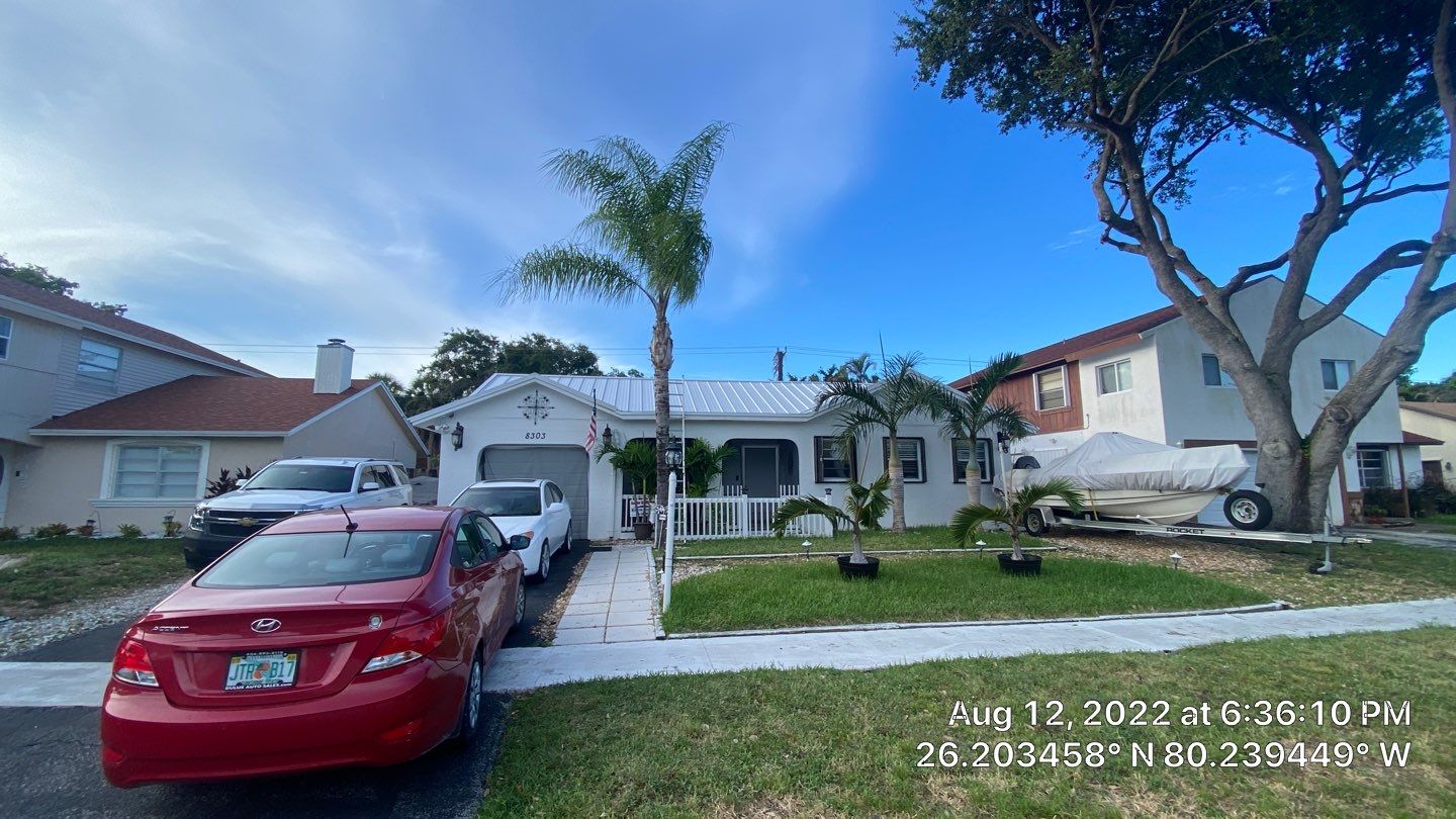 Residential Roofing Installation using 1.5" Nail Strip 24ga Solar White Kynar Coated Standing Seam Metal Panels by Morton Roofing, Inc.