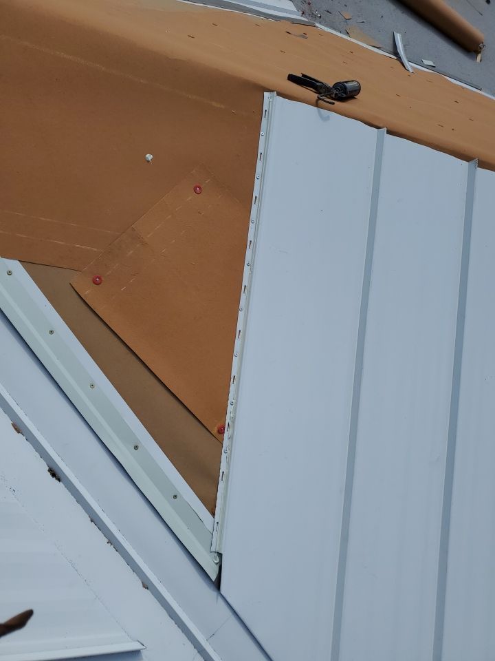 Residential Roofing Installation using 1.5" Nail Strip 24ga Solar White Kynar Coated Standing Seam Metal Panels by Morton Roofing, Inc.