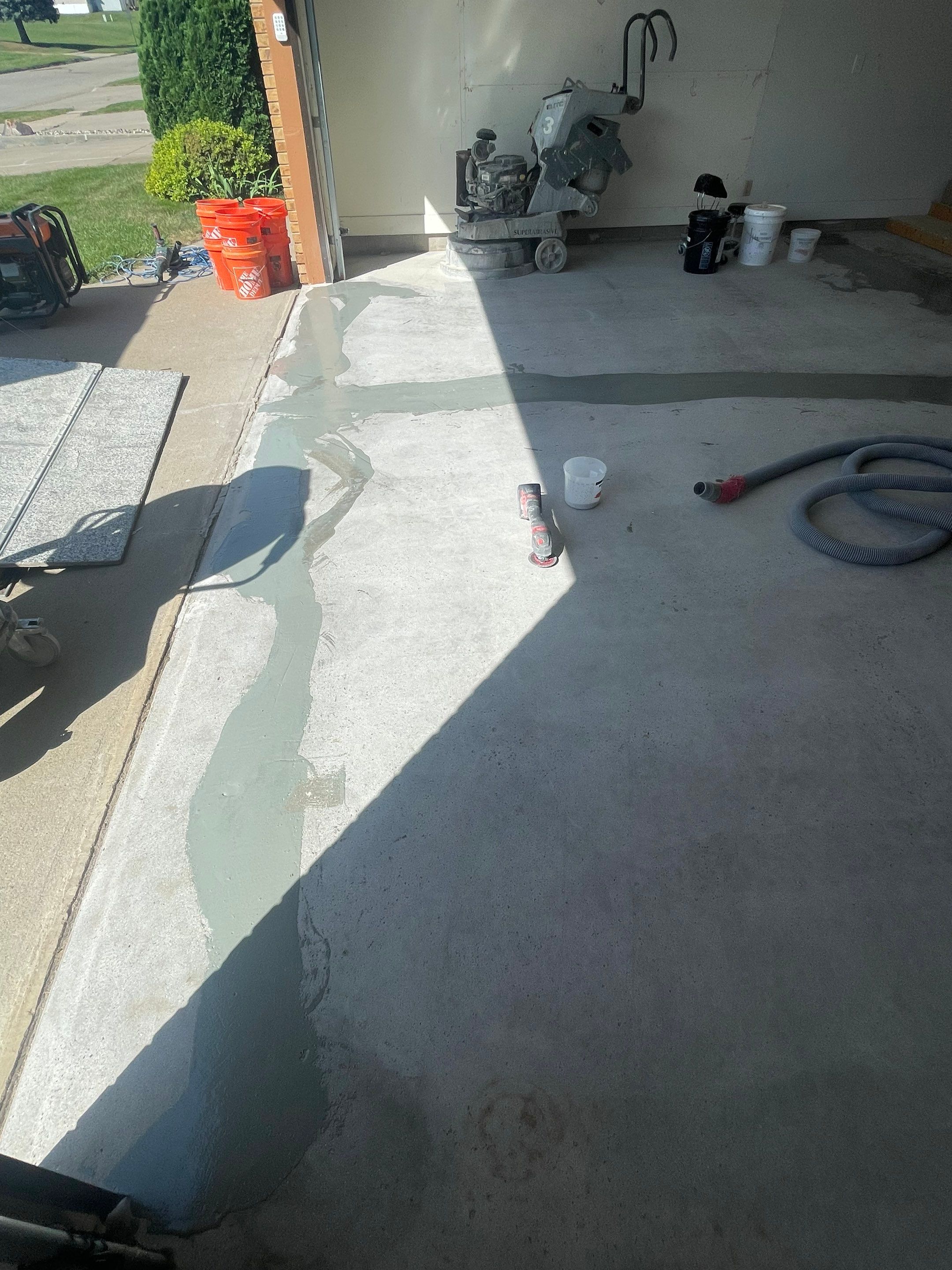 Grey Speckled Concrete Coating for Residential Garage in Yankton by Select Painting, Coatings & Garage Cabinets