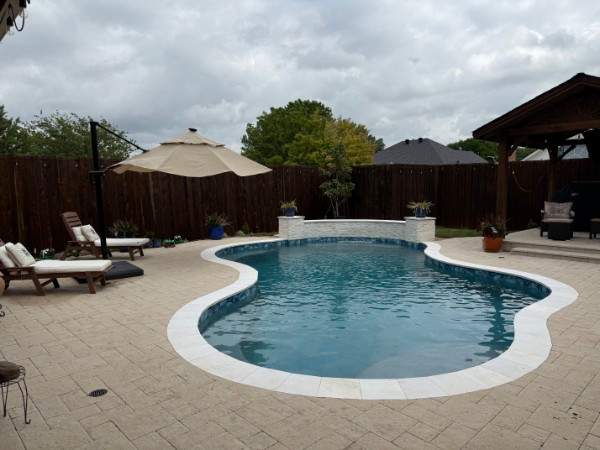 Resort-Style Freeform Pool with Travertine Decking by Pinnacle Pools and Spas - DFW