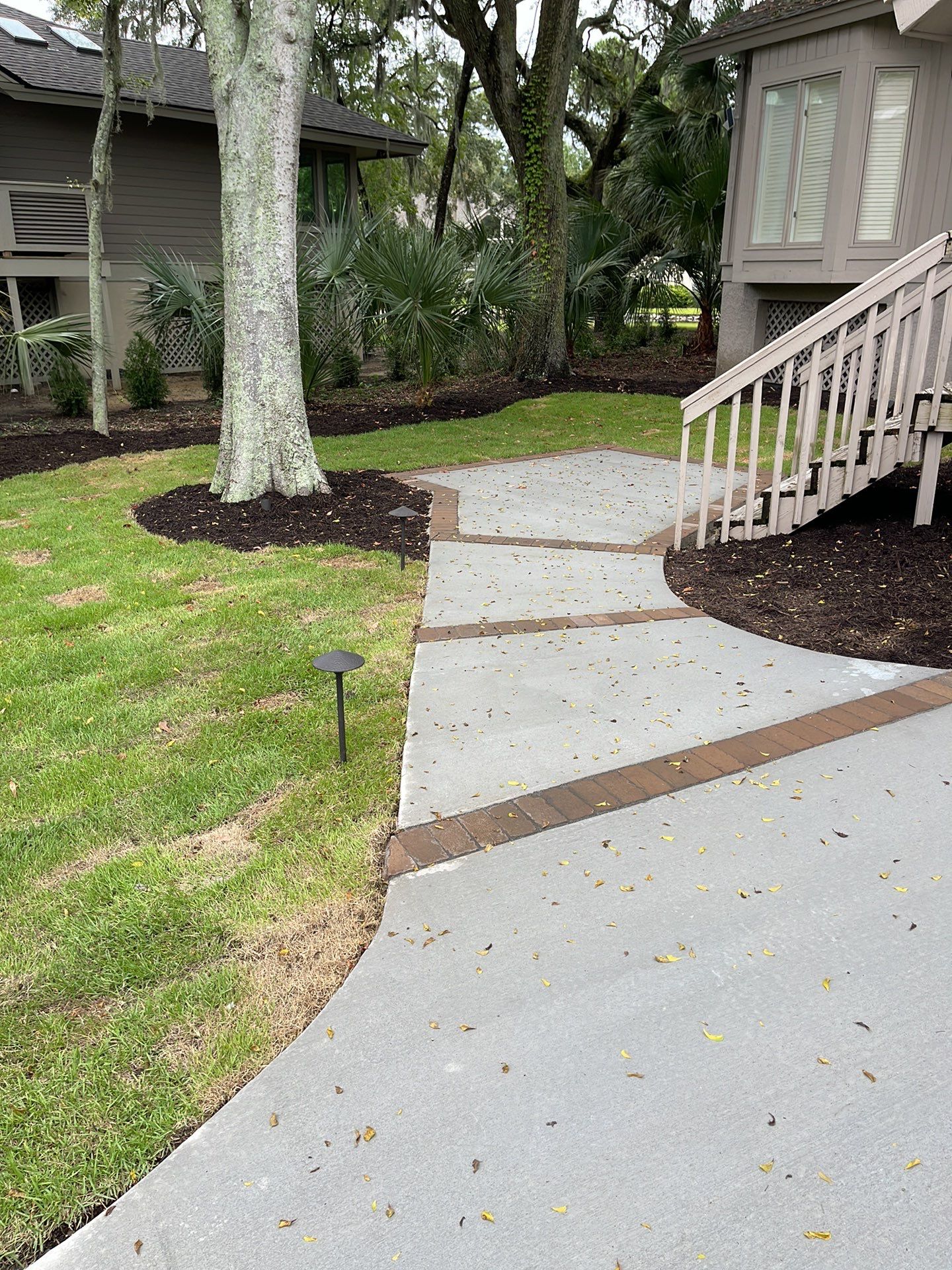 Concrete Driveway Replacement with Brick Paver Accents in Hilton Head Island by Lowcountry Scapes, LLC