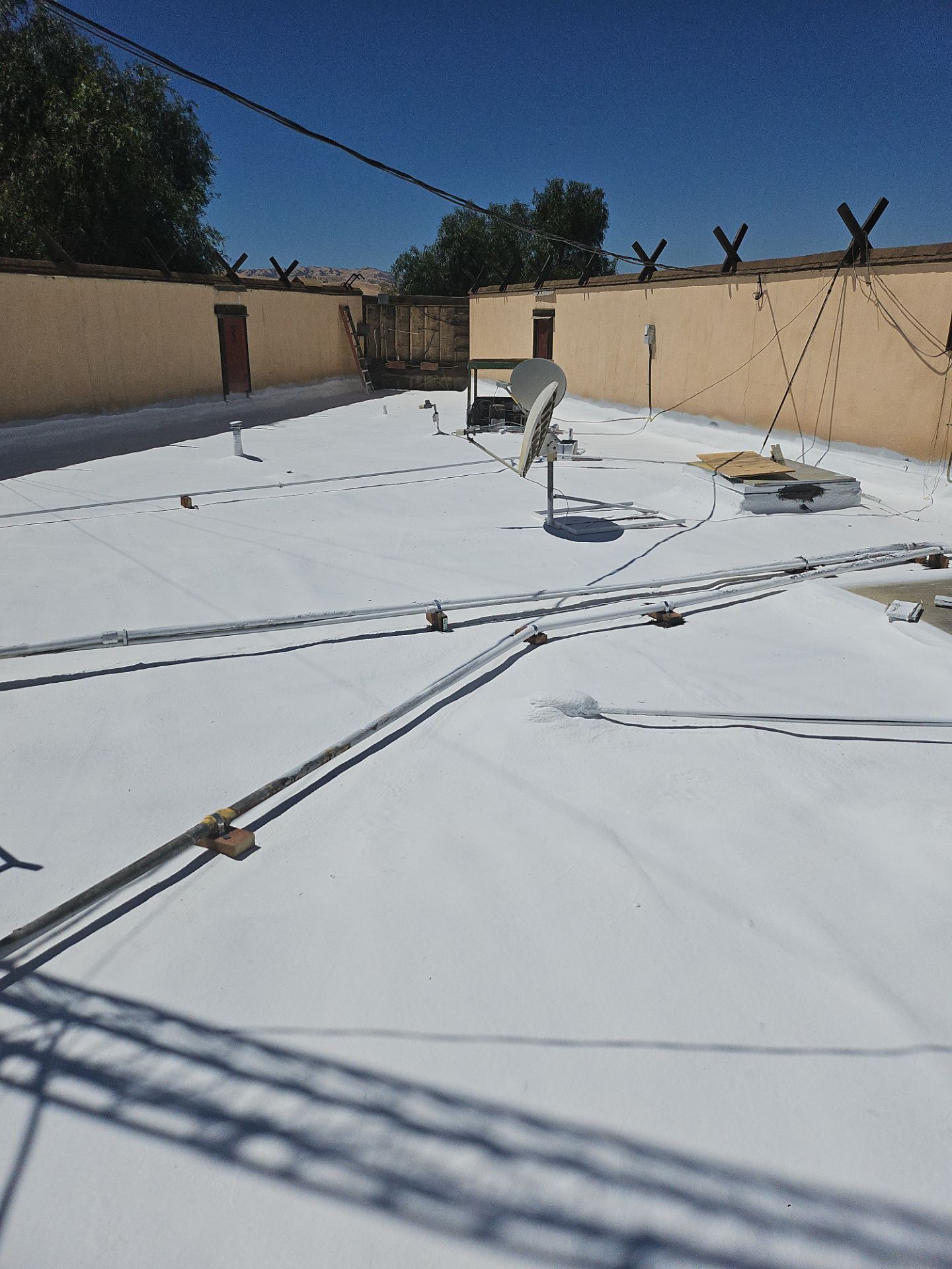 Spray foam and coatings using General Coatings acrylic coatings and spray foam by Straight Edge Roofing Inc