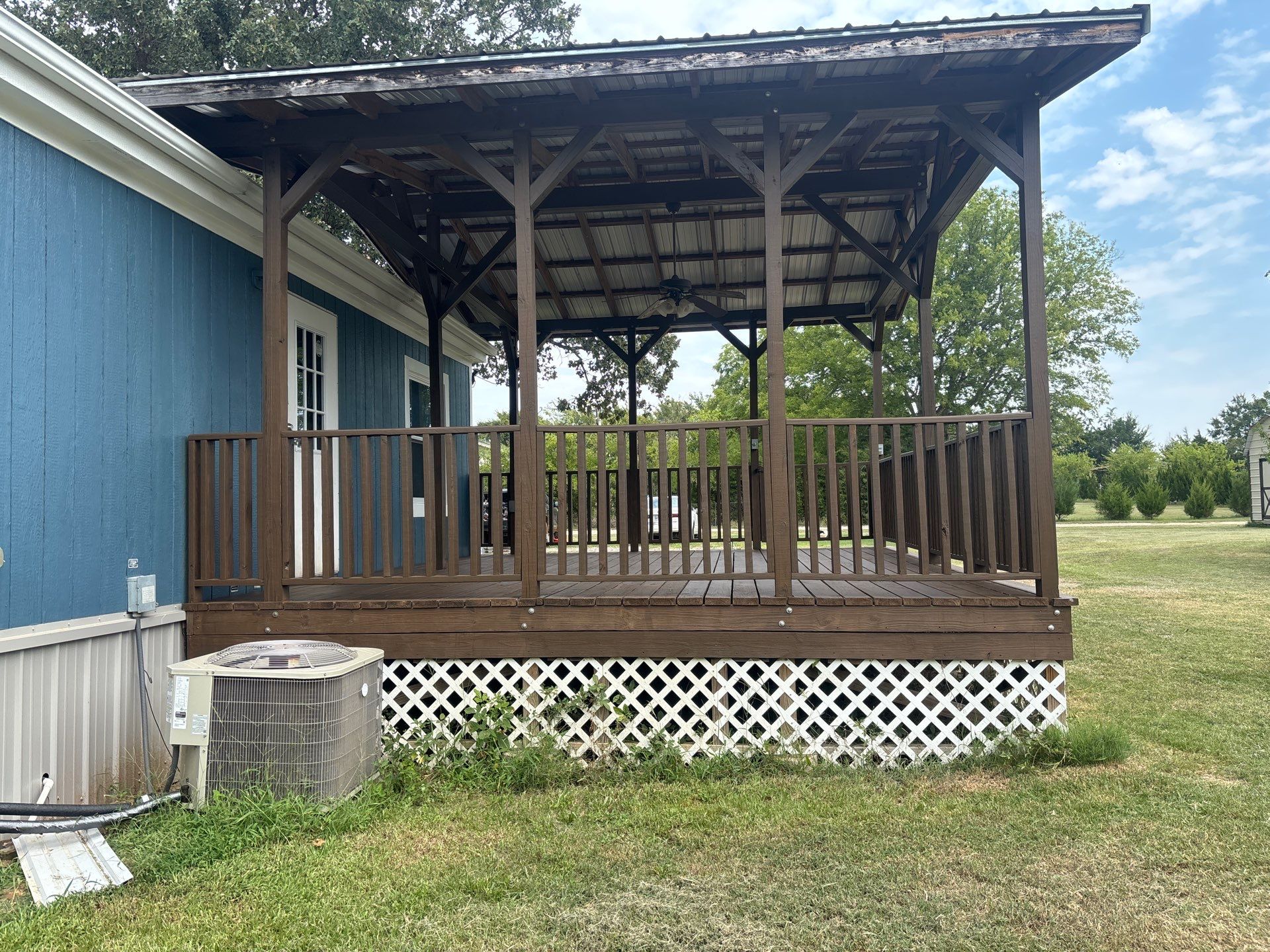 Exterior Painting in Fruitvale, TX | Wood Porch & Home in Deep Navy Blue by Quality Coats Painting