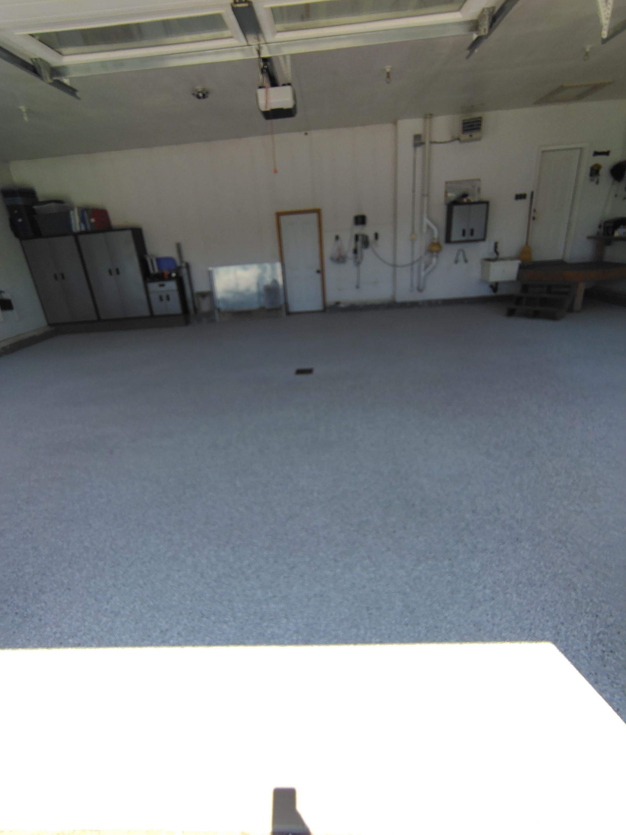 Feather Grey Garage Floor Coating Installation in Valley Springs by Select Painting, Coatings & Garage Cabinets