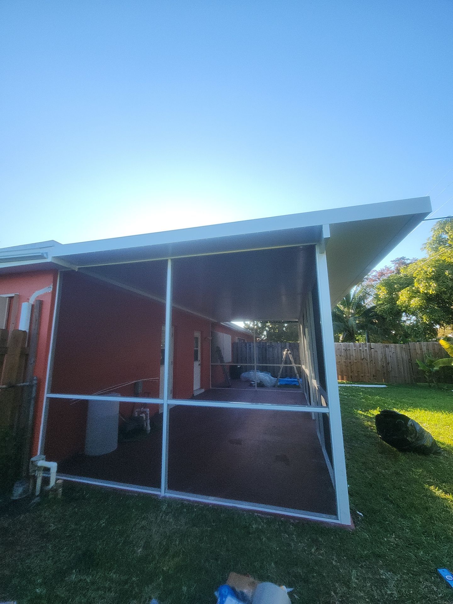 Insulated Screen Enclosure and Wood Tile Deck Installation in Plantation by Aastro Roofing