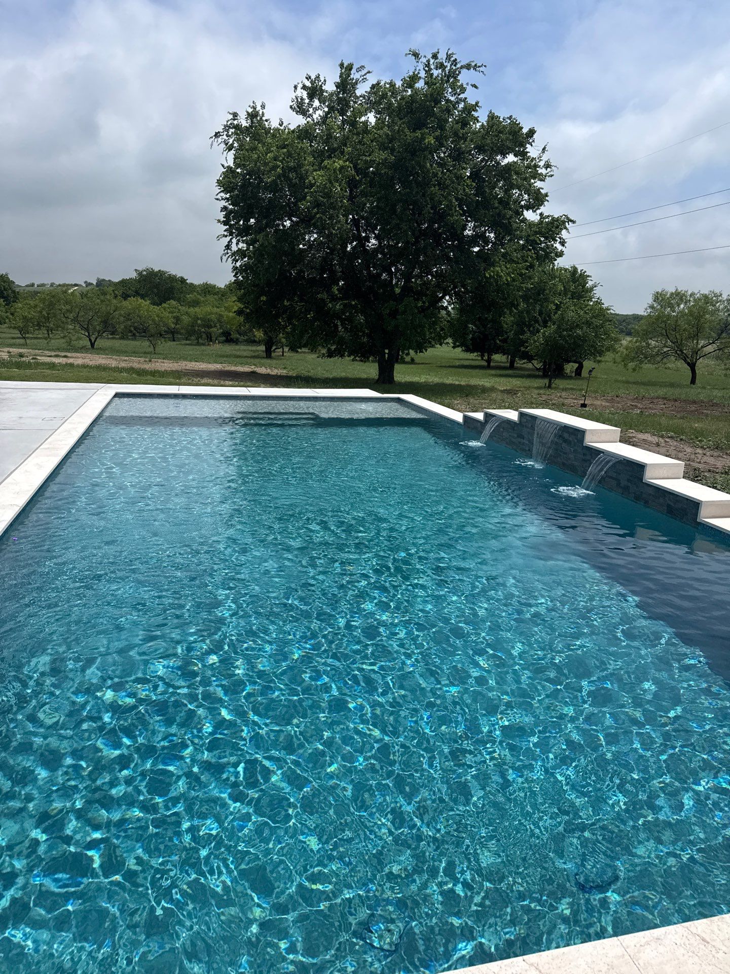 Expansive Geometric Pool with Countryside Views by Pinnacle Pools and Spas - DFW