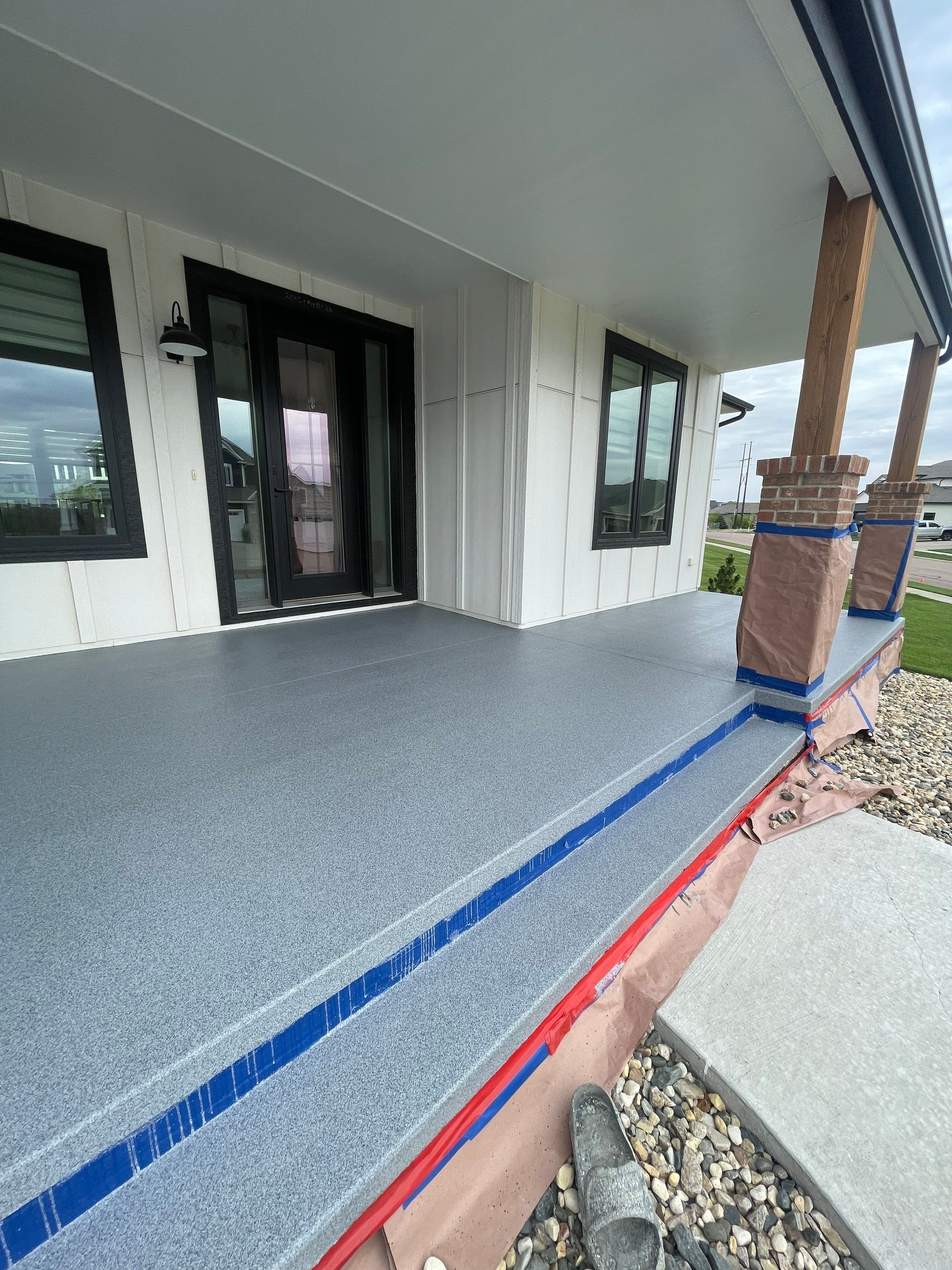 Grey Speckled Concrete Porch Coating for Sioux Falls Home by Select Painting, Coatings & Garage Cabinets