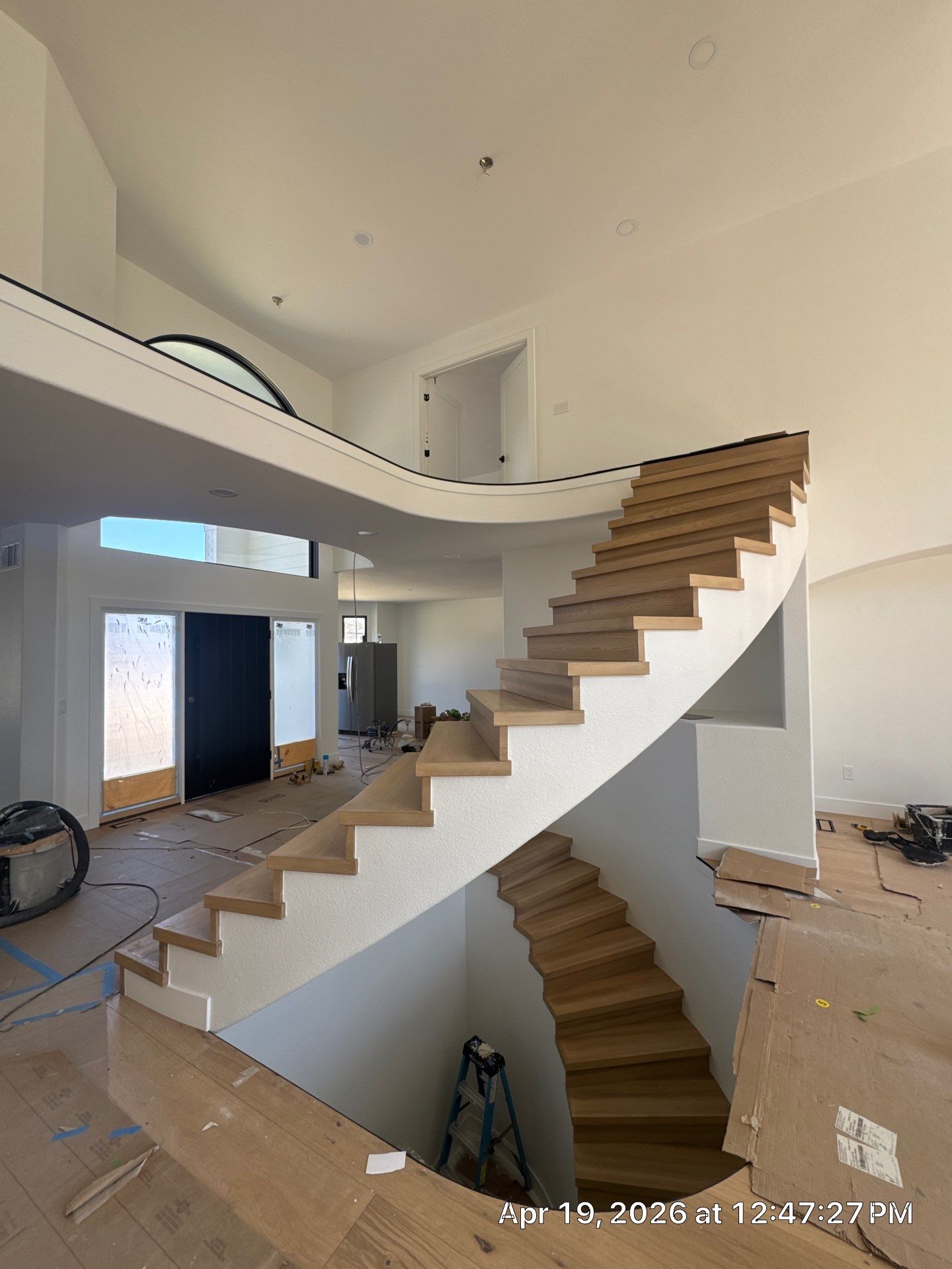 Curved Oak Staircase and Custom Metal Railing Installation in Lone Tree by LP Construction Services
