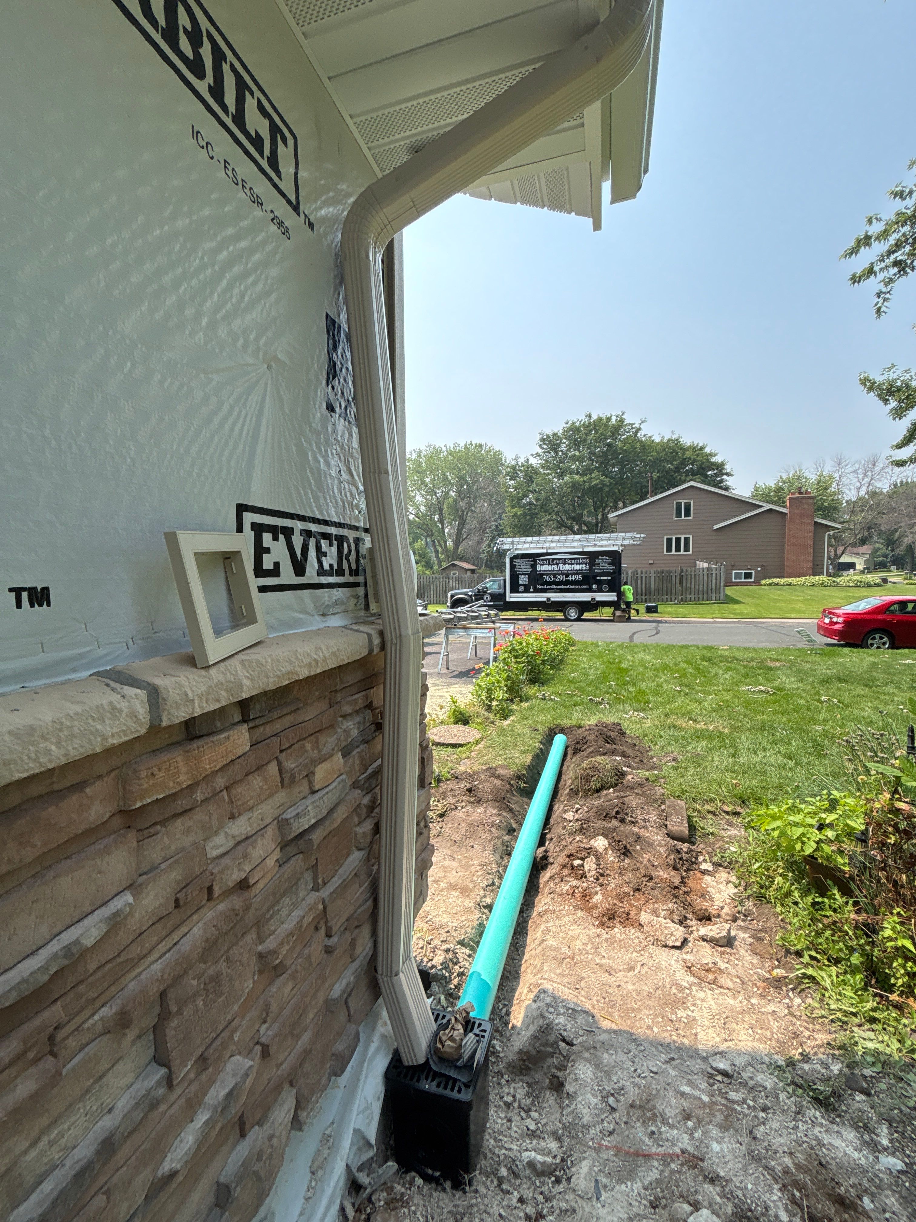 5-Inch Desert Sand Seamless Gutter Installation with Underground Drainage – Vandais Heights, MN by Next Level Seamless Gutters / Exteriors Inc.