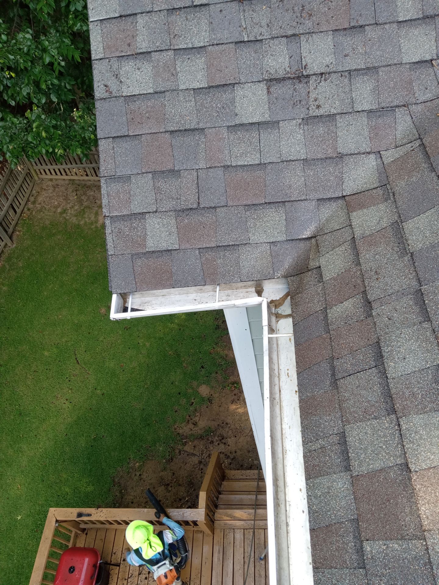 pressure washing roof gutters and deck removing dirt buildup mildew and debris for maintenance and cleanliness