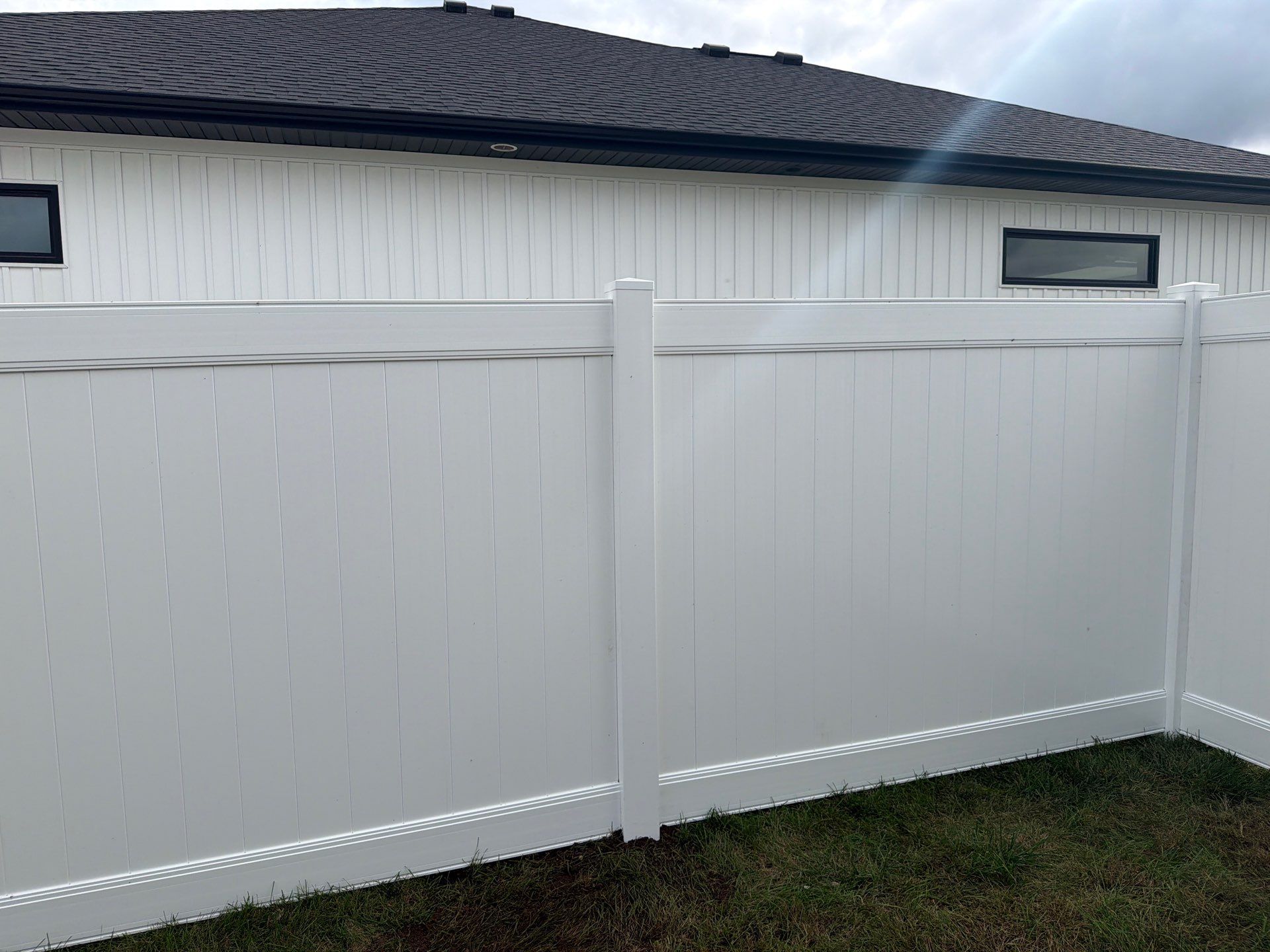 Residential White Vinyl Privacy Fence Installation in Janesville by Perfect Picket Fence and Stain