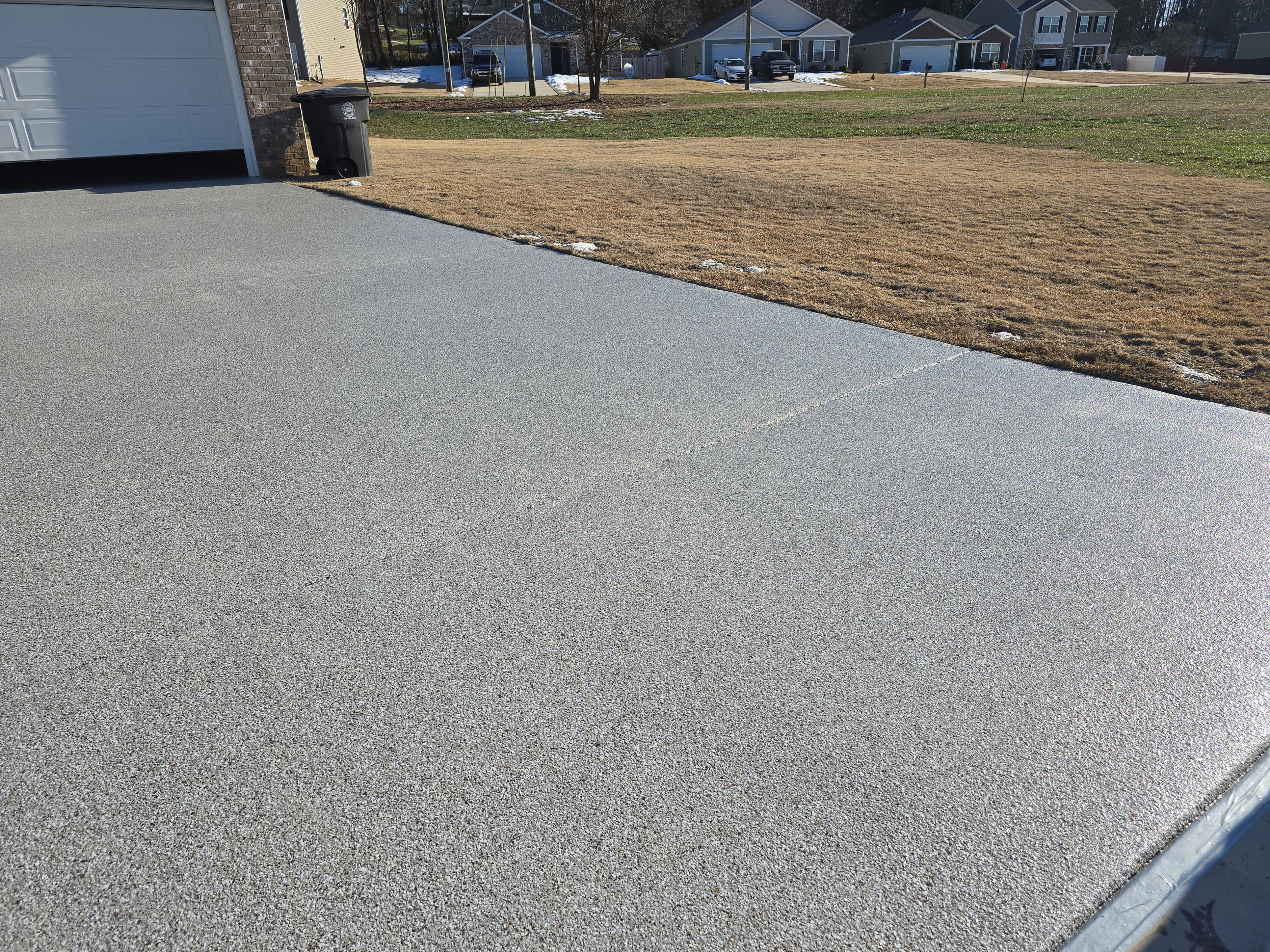 Driveway, Garage, & Front Porch using Creekbed by Elite Floor Solutions