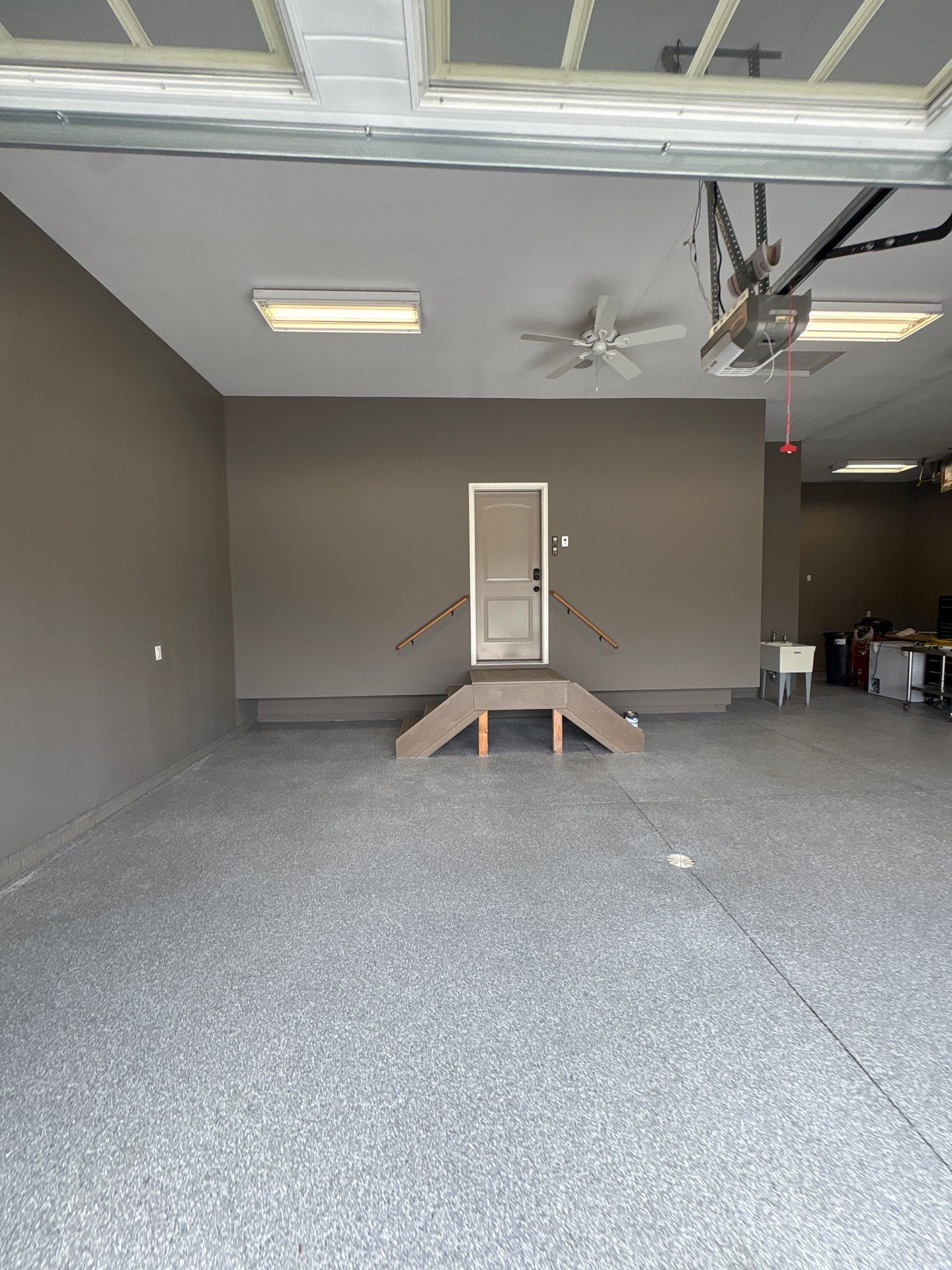 Speckled Grey Epoxy Garage Floor Coating Installation in Tea by Select Painting, Coatings & Garage Cabinets