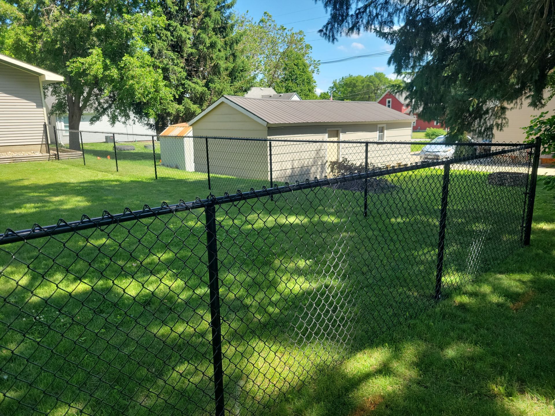 Black Chain Link Perimeter Fence and Driveway Gate in Waverly by Perfect Picket Fence and Stain