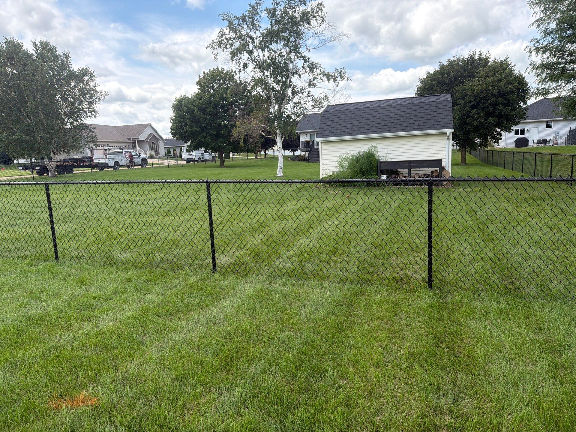 Black Vinyl-Coated Chain Link Fence Installation in Fairbank by Perfect Picket Fence and Stain