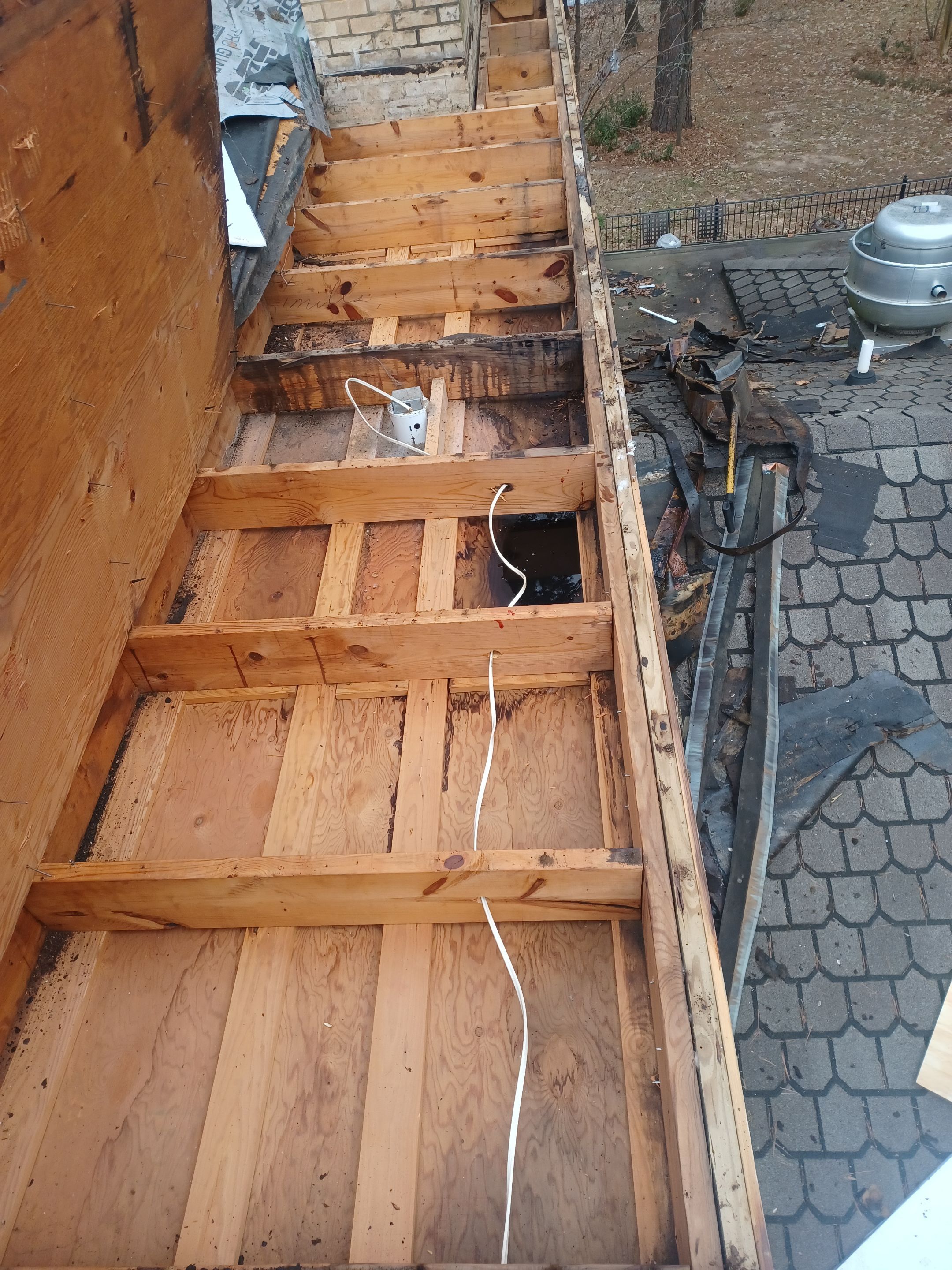 Residential Roofing Installation using PVC membrane and 24 gauge Standing Seam Metal by Hostetler Roofing
