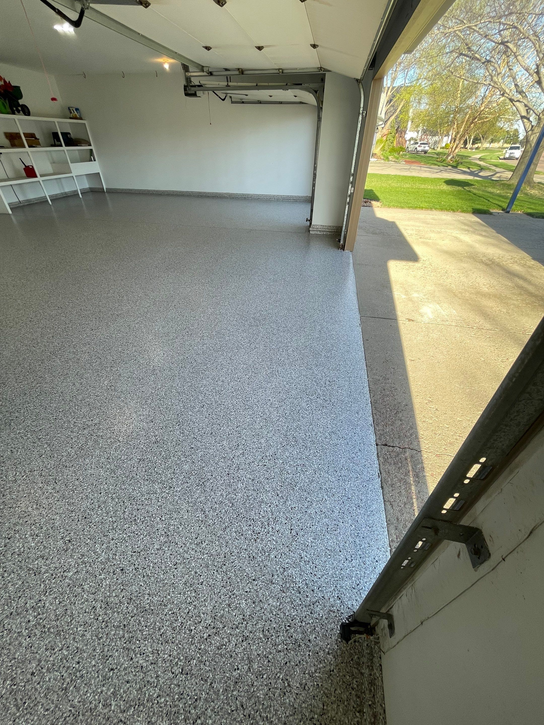 Yankton Garage Floor Restoration with Gray Speckled Epoxy Coating by Select Painting, Coatings & Garage Cabinets